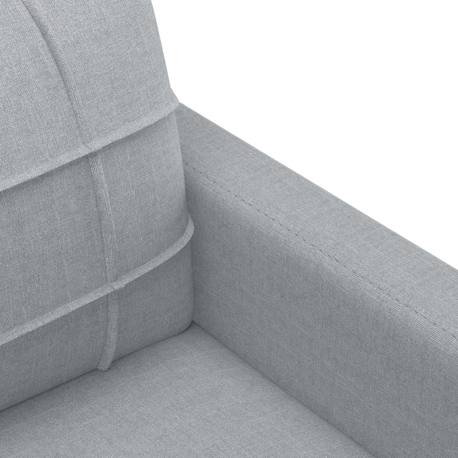 Nahaufnahme eines grauen Sofas mit strukturierter Oberfläche und sichtbaren Nähten.