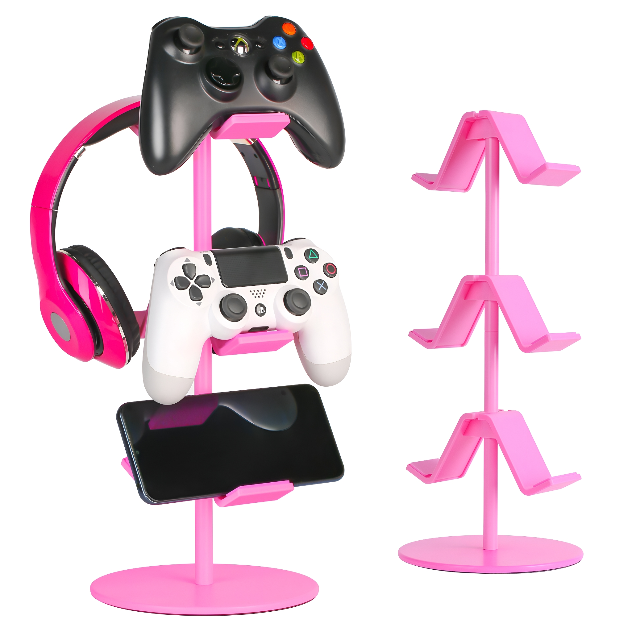 Ein pinkfarbener Ständer, der ein schwarzes Gamepad, ein weißes Gamepad, pinkfarbene Kopfhörer und ein Telefon hält.