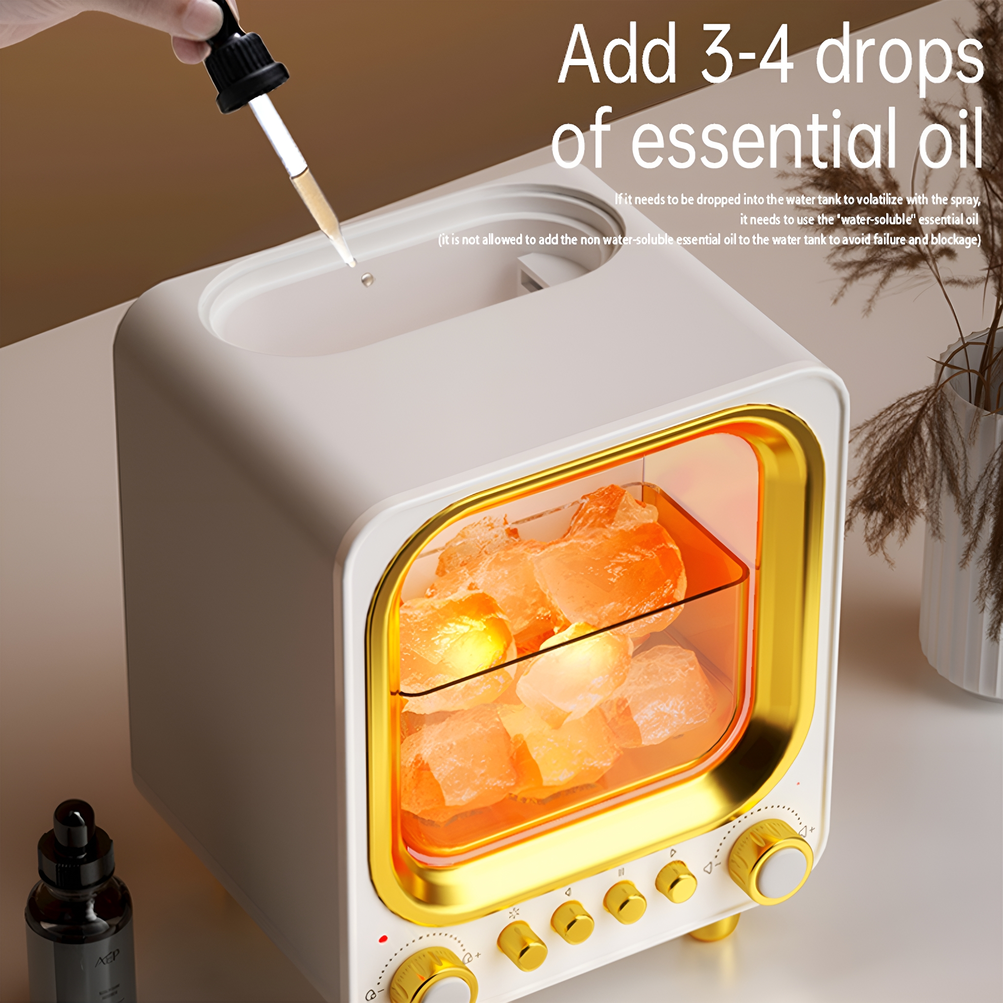Ein weißer und goldener Diffusor für ätherische Öle, mit Steinen und Tropfer.