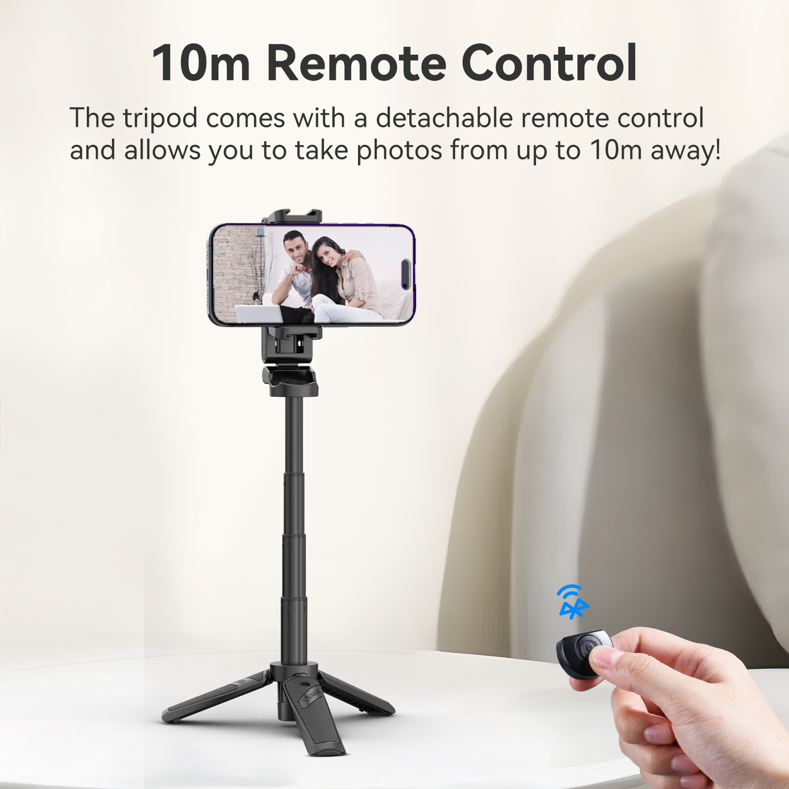 Tripod with phone. Remote control in hand, two people on the screen.