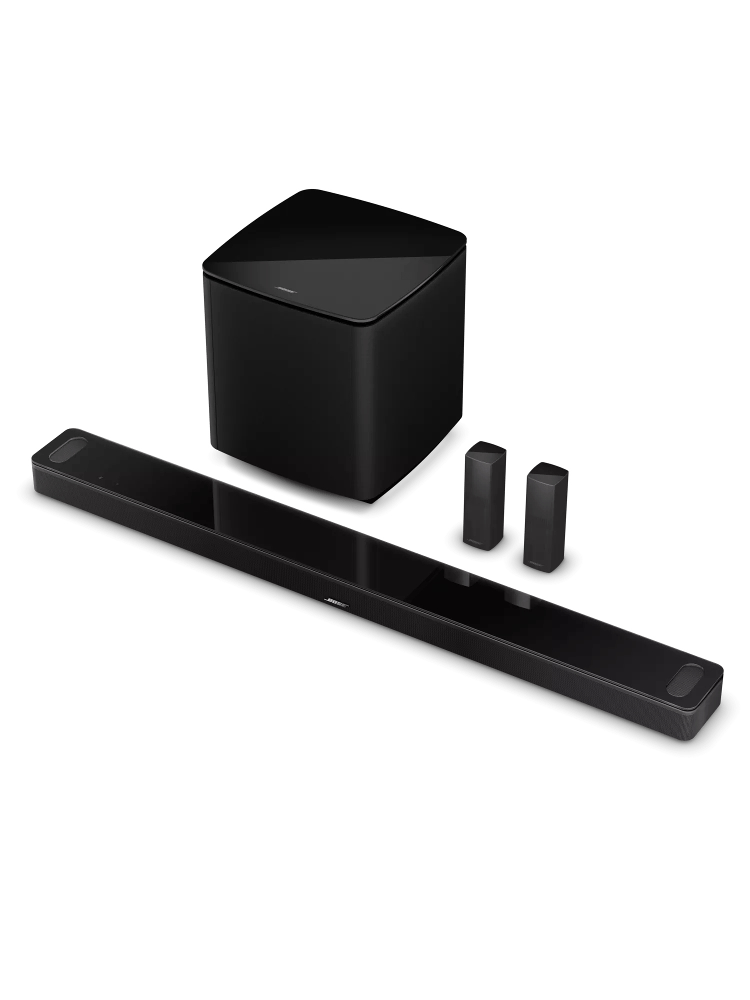 Sistema de sonido negro con barra de sonido, subwoofer y dos altavoces pequeños.