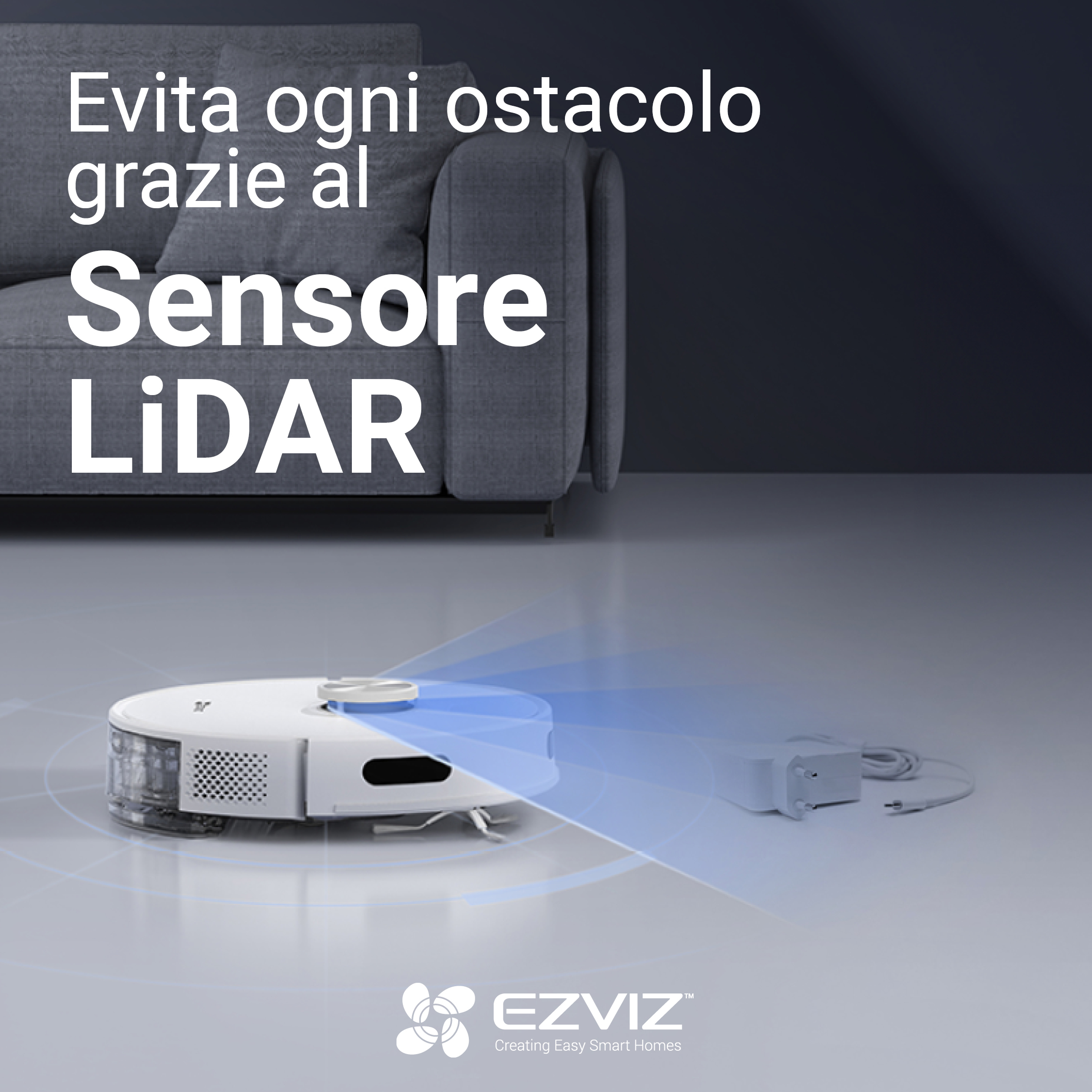 Biały robot odkurzający sprząta pokój. Podłączona jest stacja ładująca.