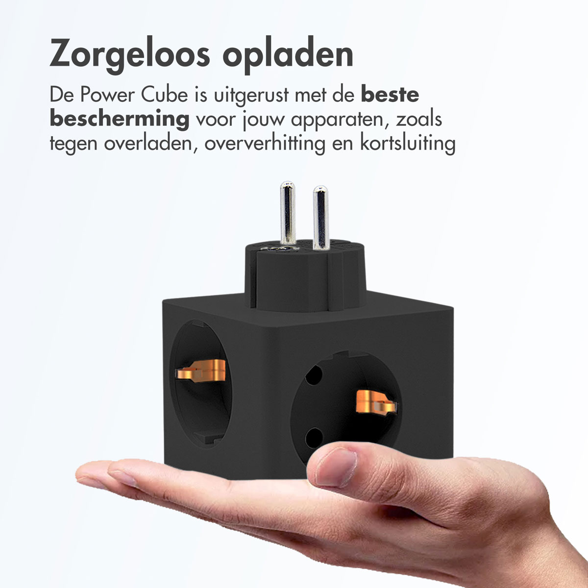 A black power cube held in a hand, highlighting its safe charging features.