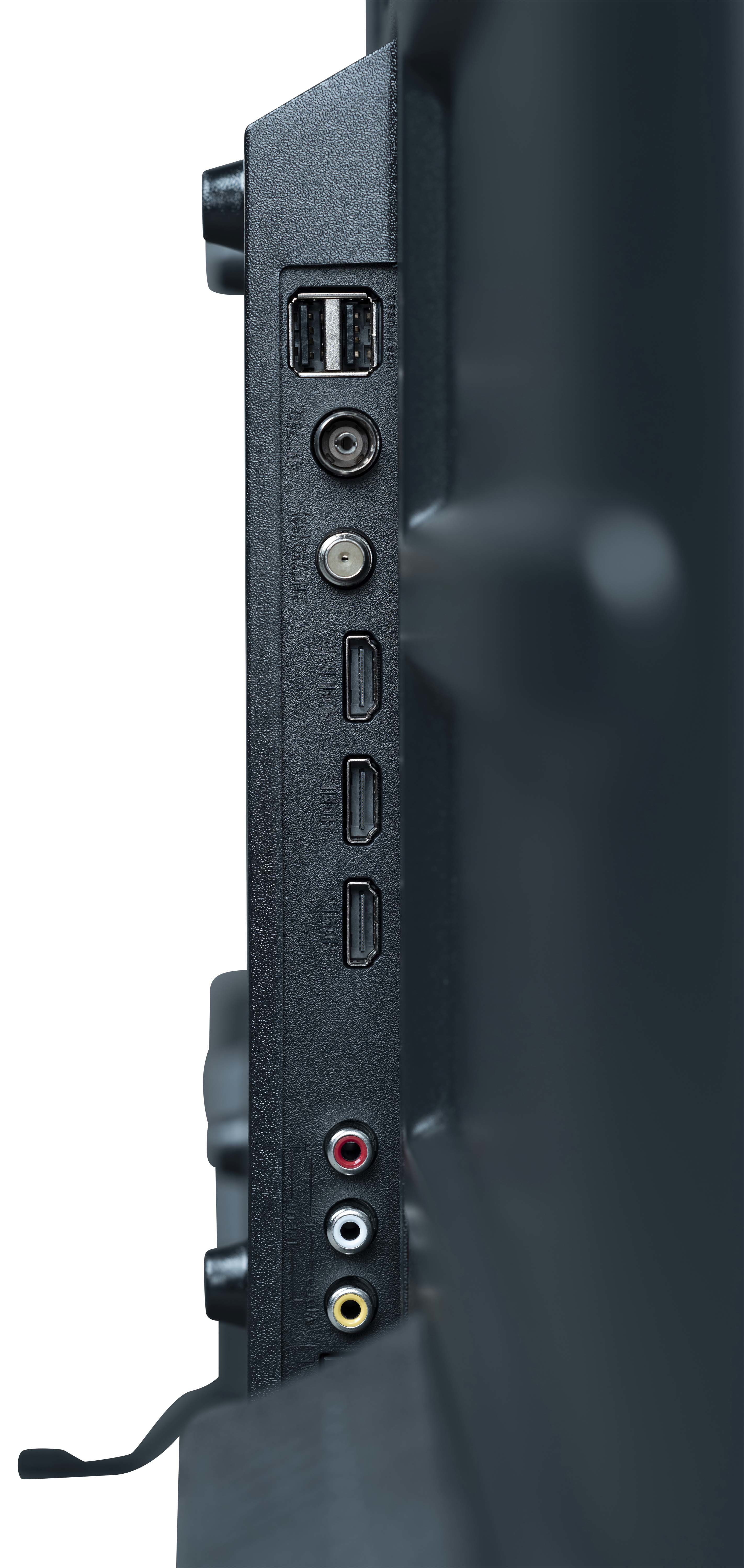 Vista ravvicinata del lato di una TV nera, che mostra le porte: USB, antenna, HDMI e uscite audio.