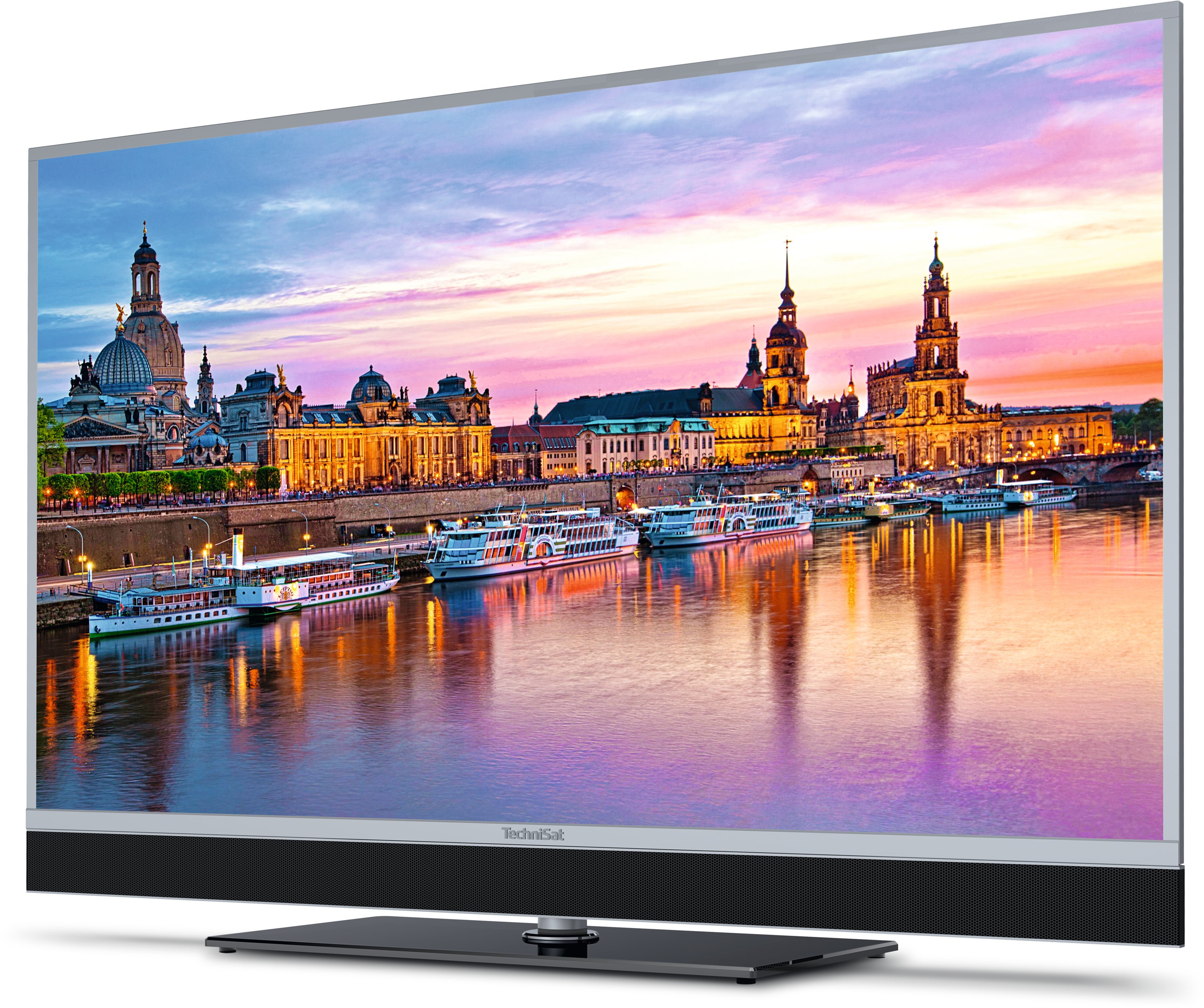 Telewizor wyświetla malowniczy widok na miasto, z łodziami na wodzie.