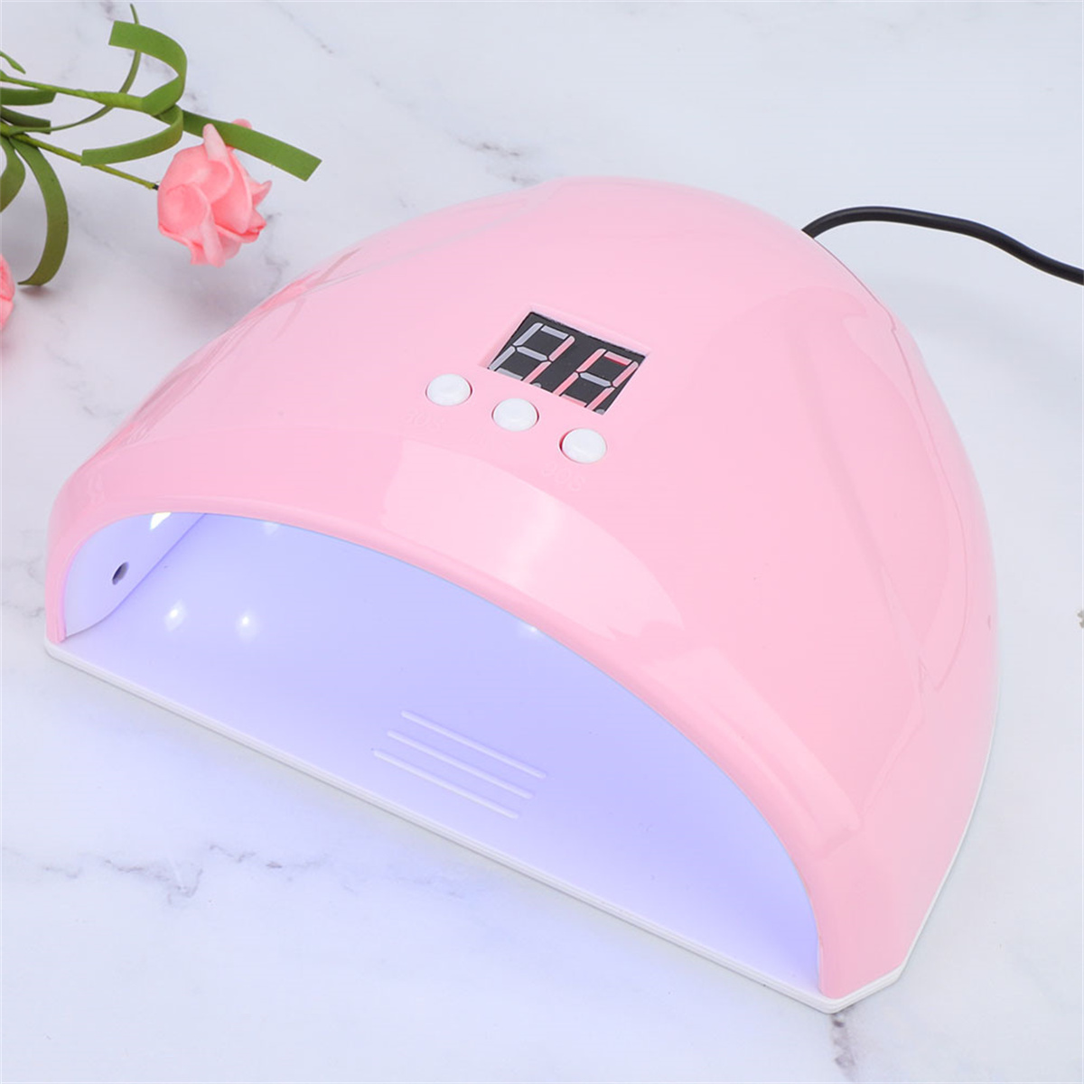 Rosa UV-Nagellampe, weißes Innere, Knöpfe und Digitalanzeige.