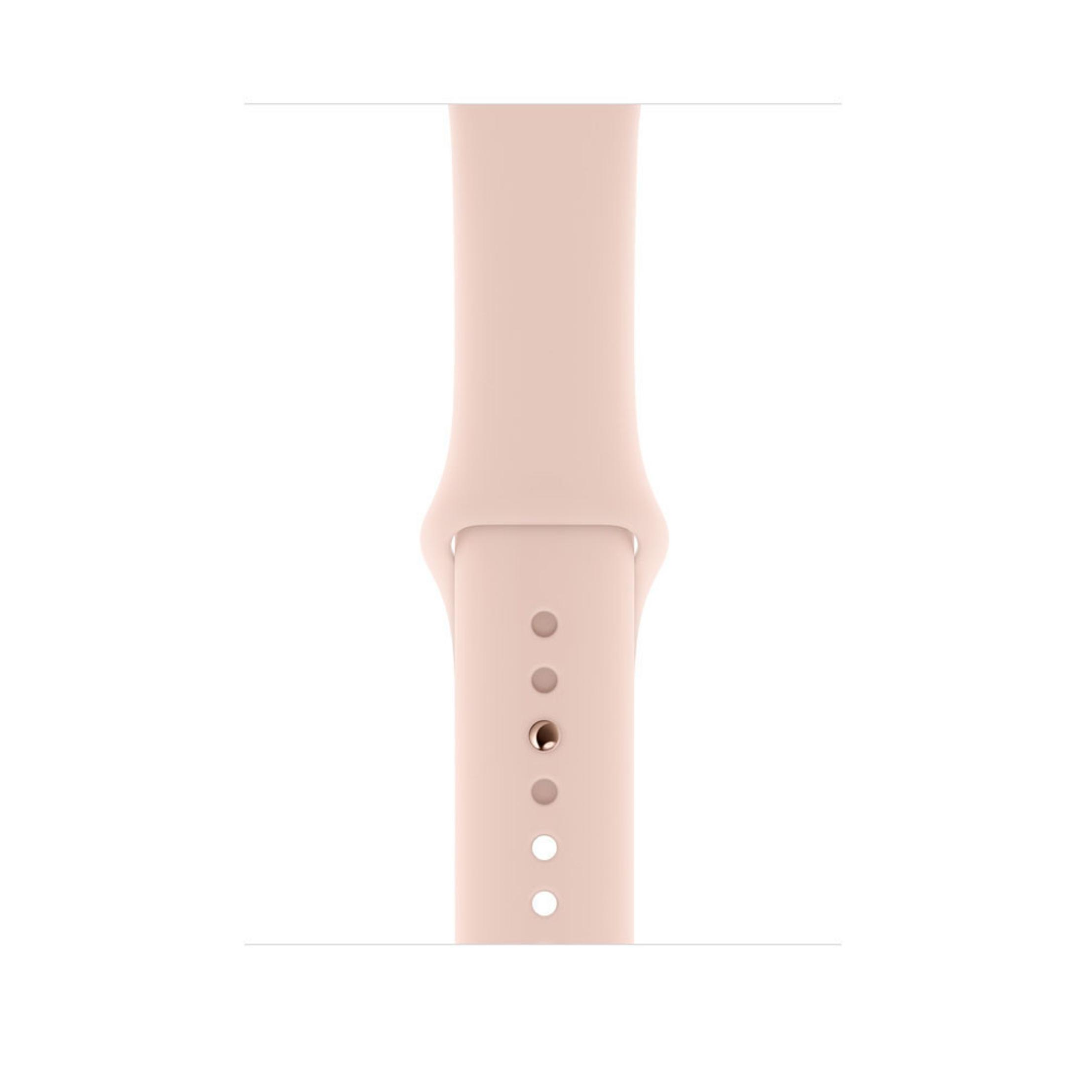 Primer plano de una correa rosa de Apple Watch con varios agujeros, fondo blanco.