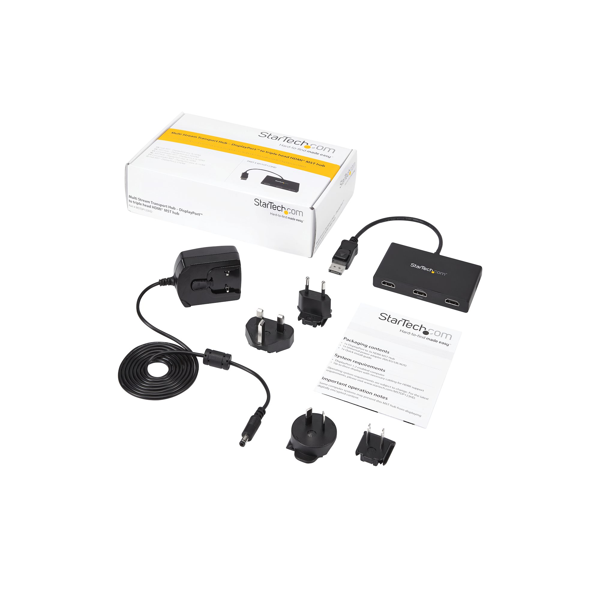 Una caja Startech abierta con un adaptador de corriente, enchufes y otros accesorios sobre una superficie blanca.