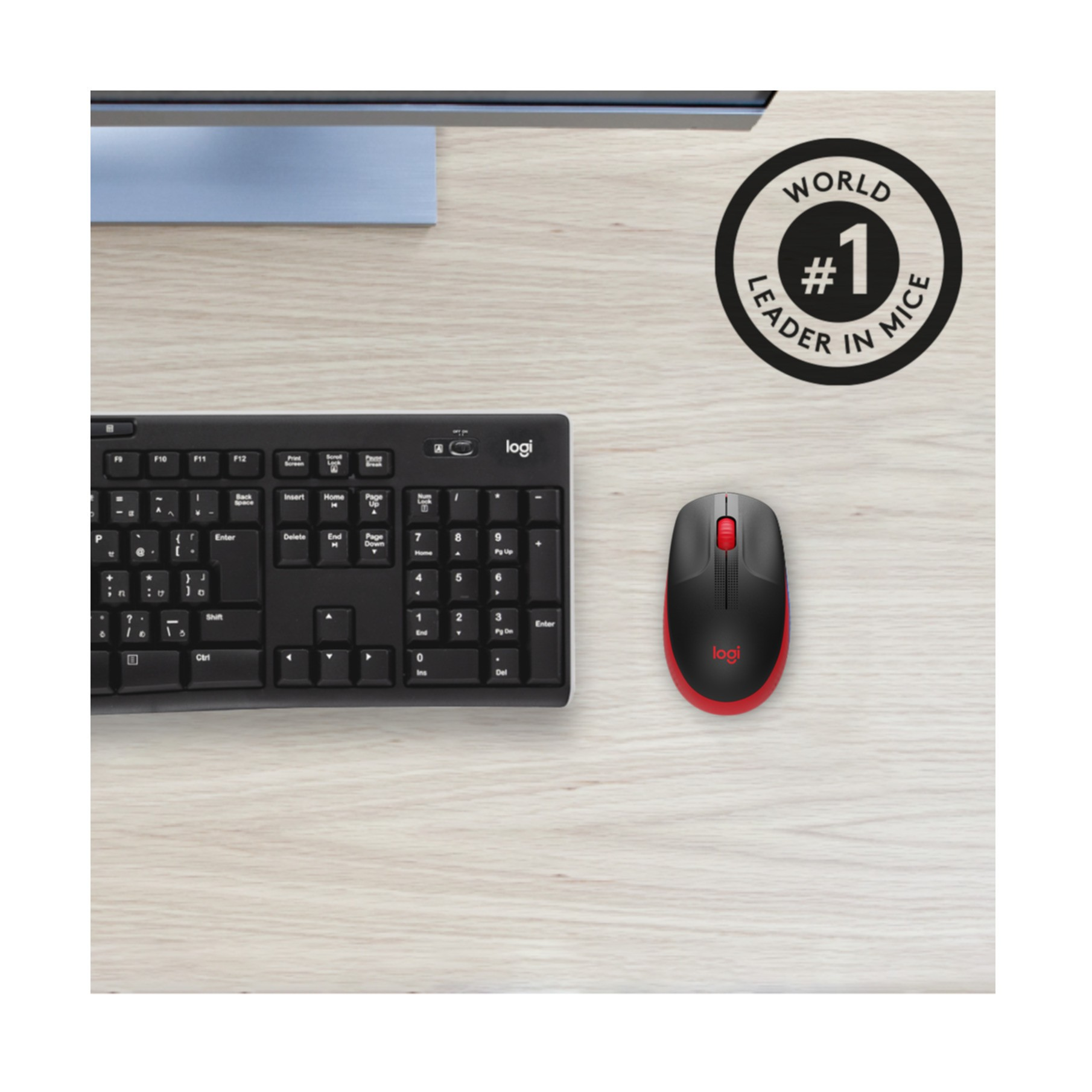 Black and red mouse and a black keyboard on a wooden desk. A sign says 'Leader in Mice'.