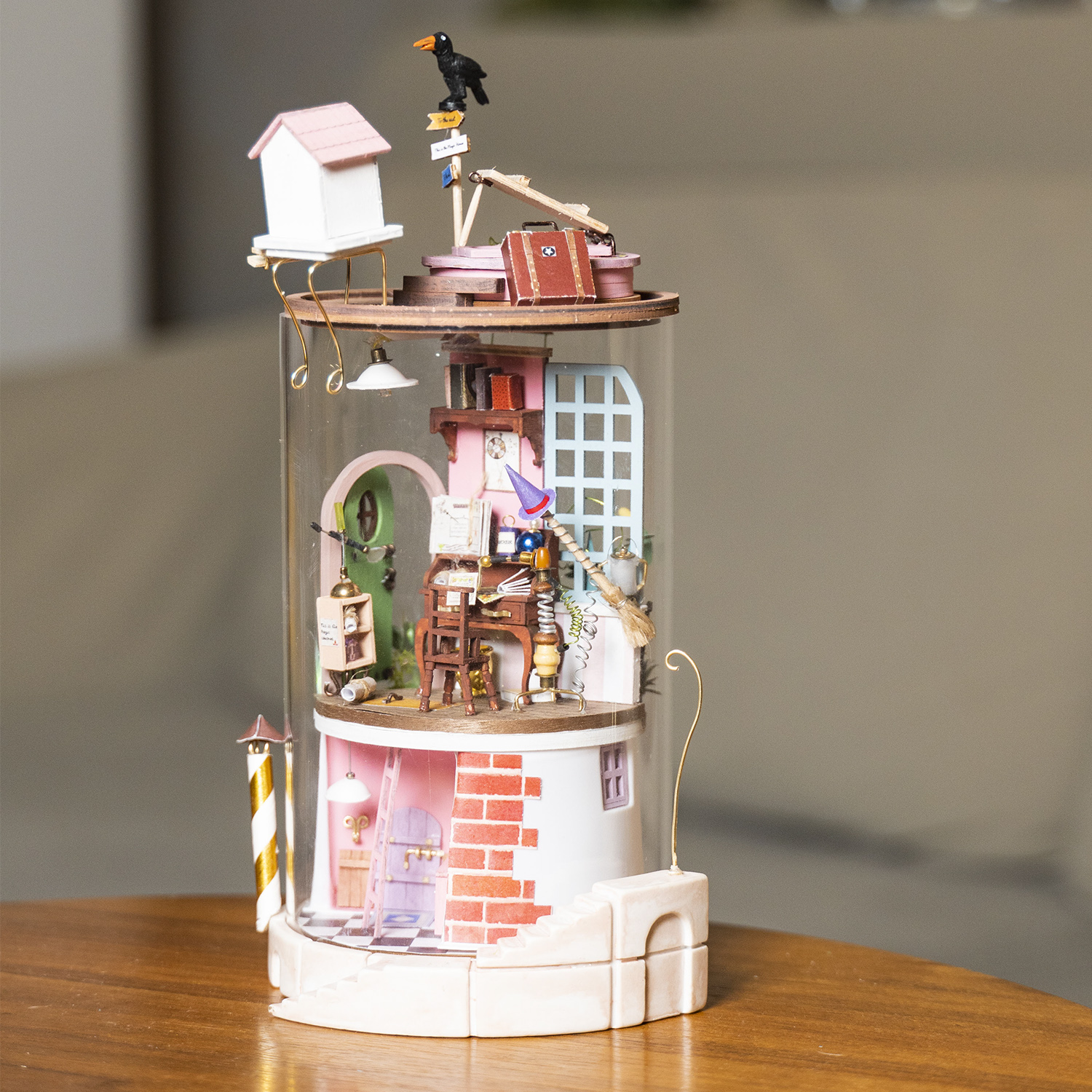 Torre in miniatura con varie stanze, tra cui una casetta per uccelli, una scrivania e una stanza della strega.