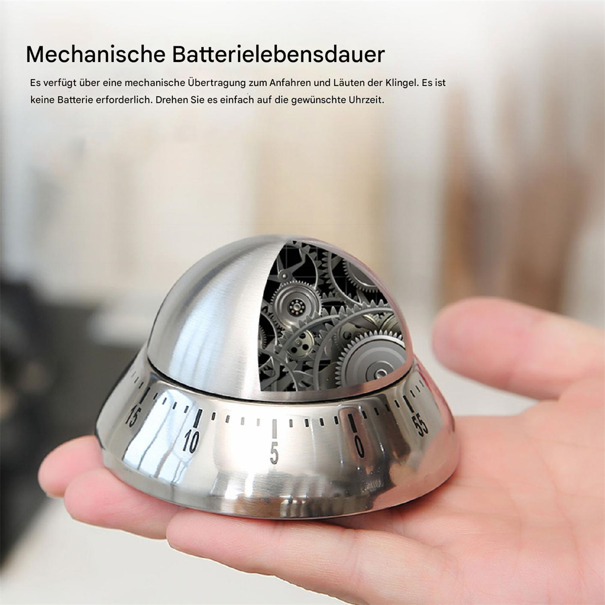 Silberner eiförmiger Küchentimer mit Fenster, das Zahnräder und eine Skala zeigt.