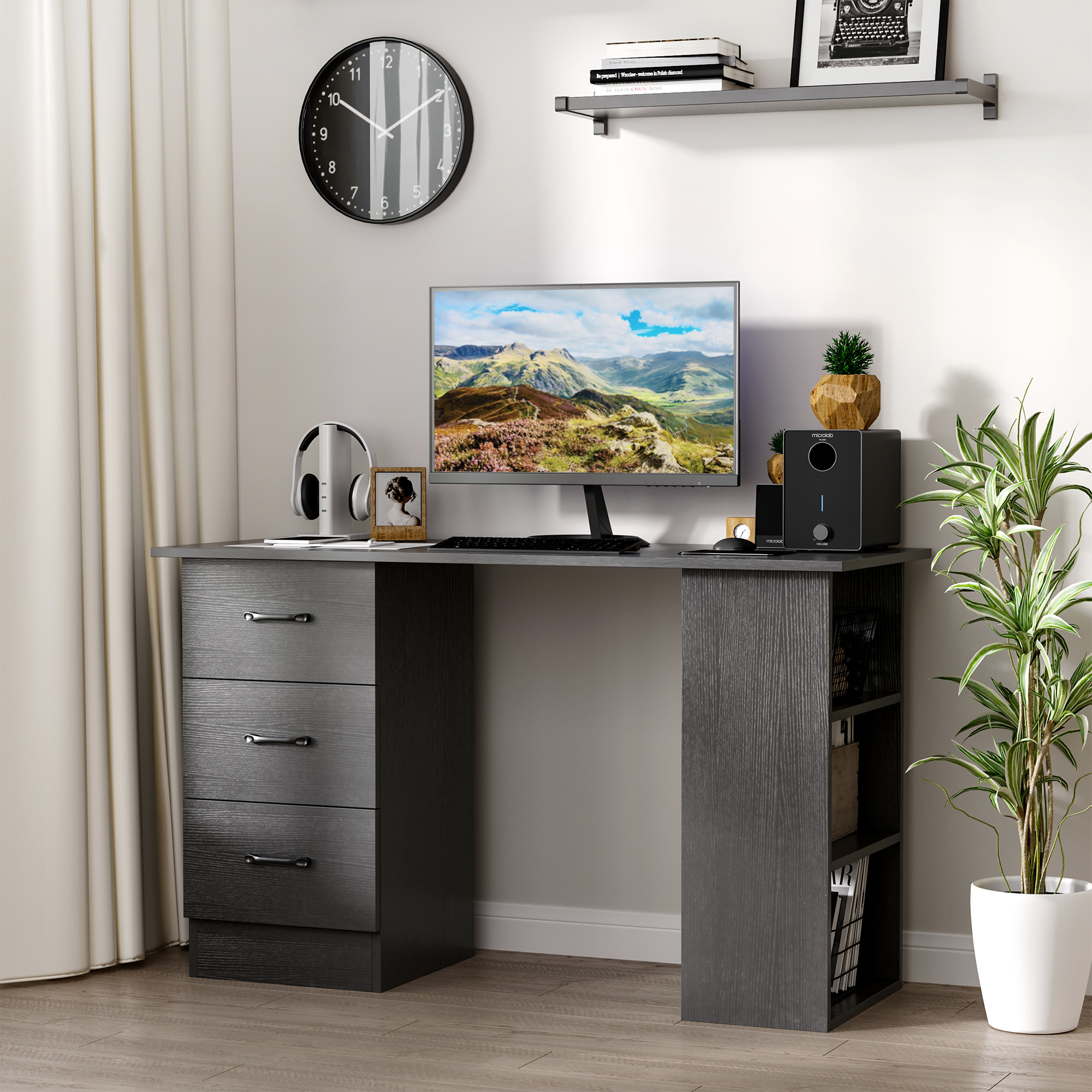 Scrivania grigio scuro con cassetti, monitor, altoparlanti, orologio e pianta, con tenda bianca.