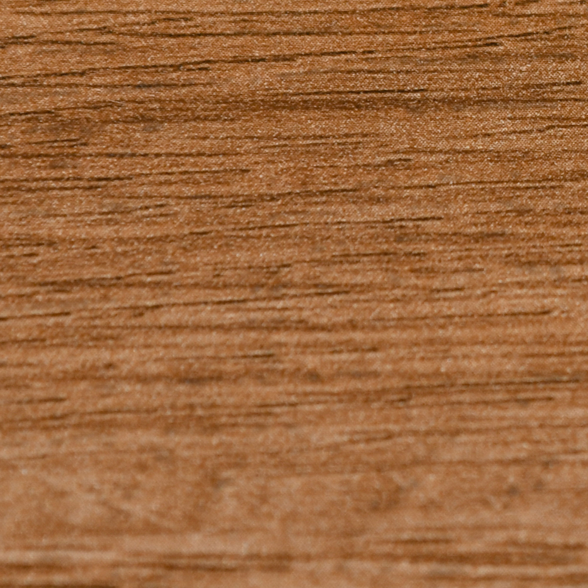 Primo piano di una texture di legno con colore marrone chiaro e venature visibili.