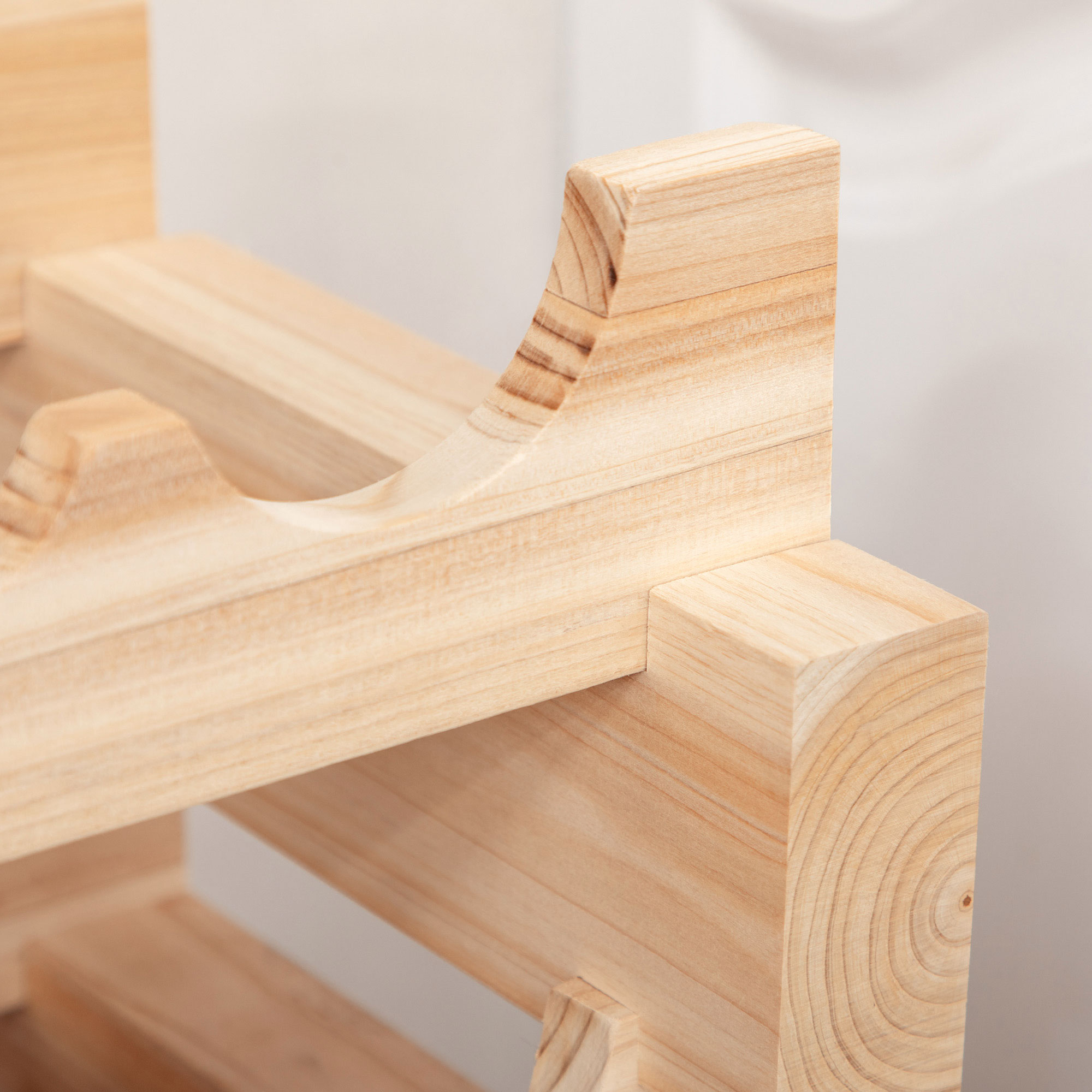 Primo piano del dettaglio strutturale di un portabottiglie in legno, che mostra la venatura.