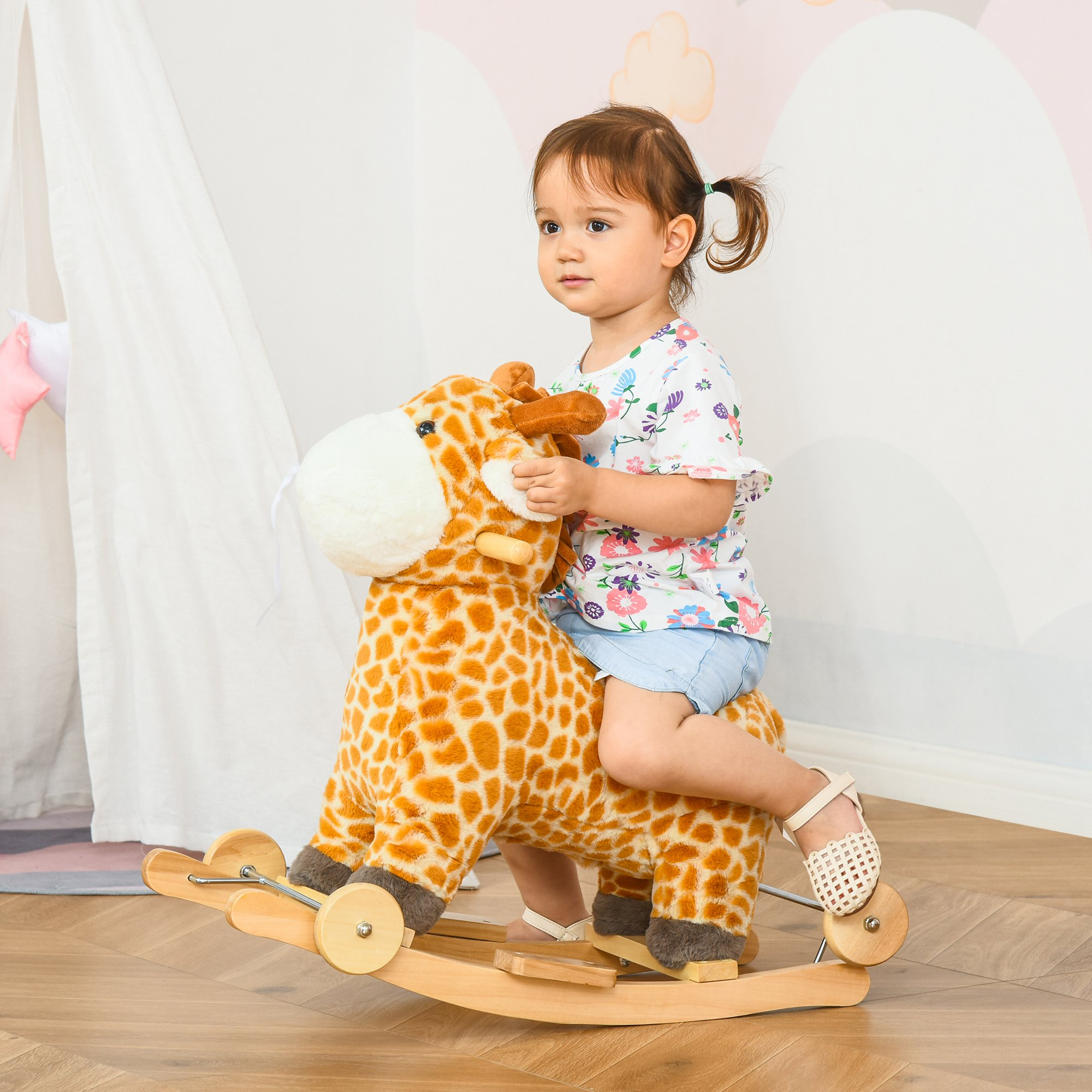 Bambino su un cavallo a dondolo giraffa. Il bambino guarda avanti.
