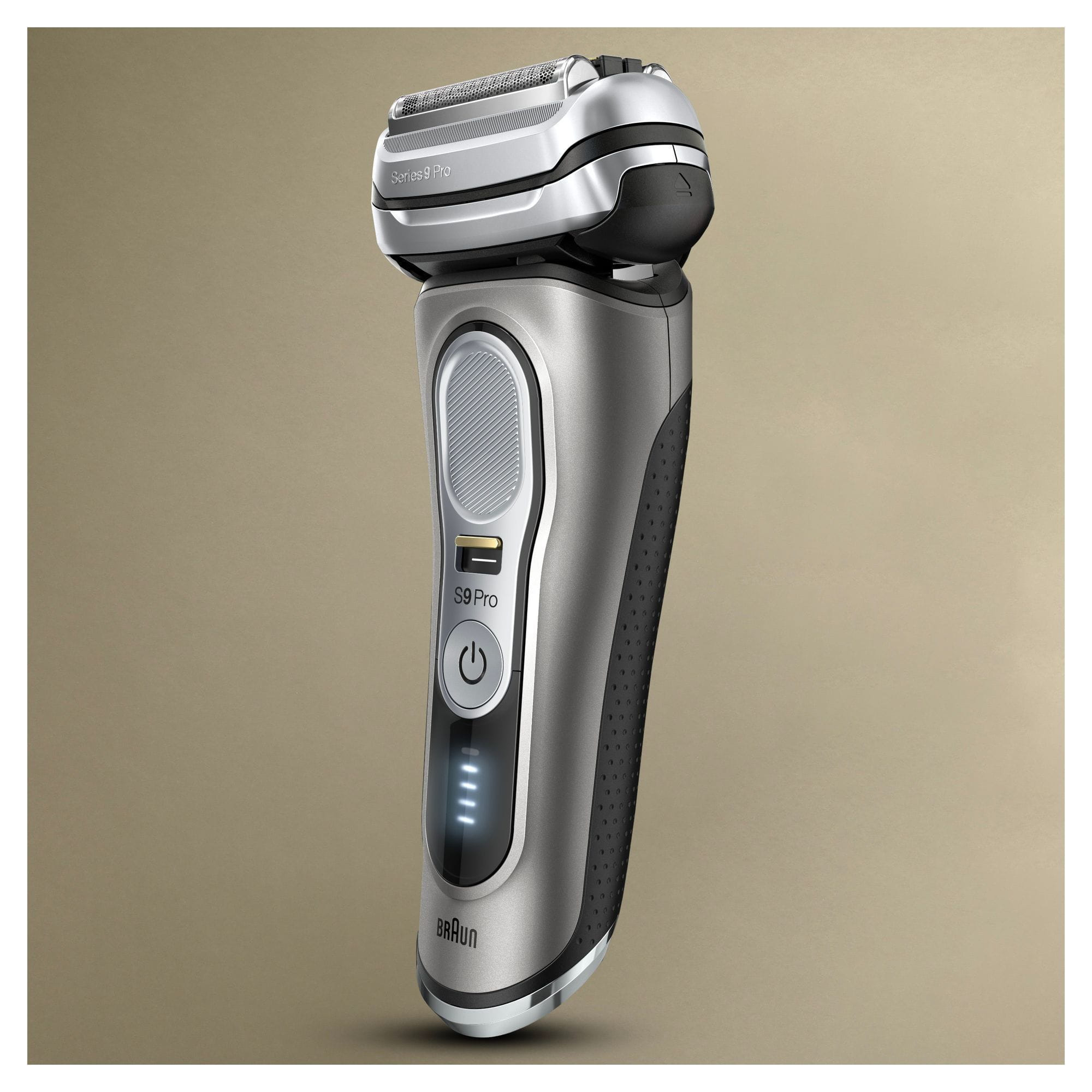 A silver and grey electric shaver. It shows the power button and battery indicator.