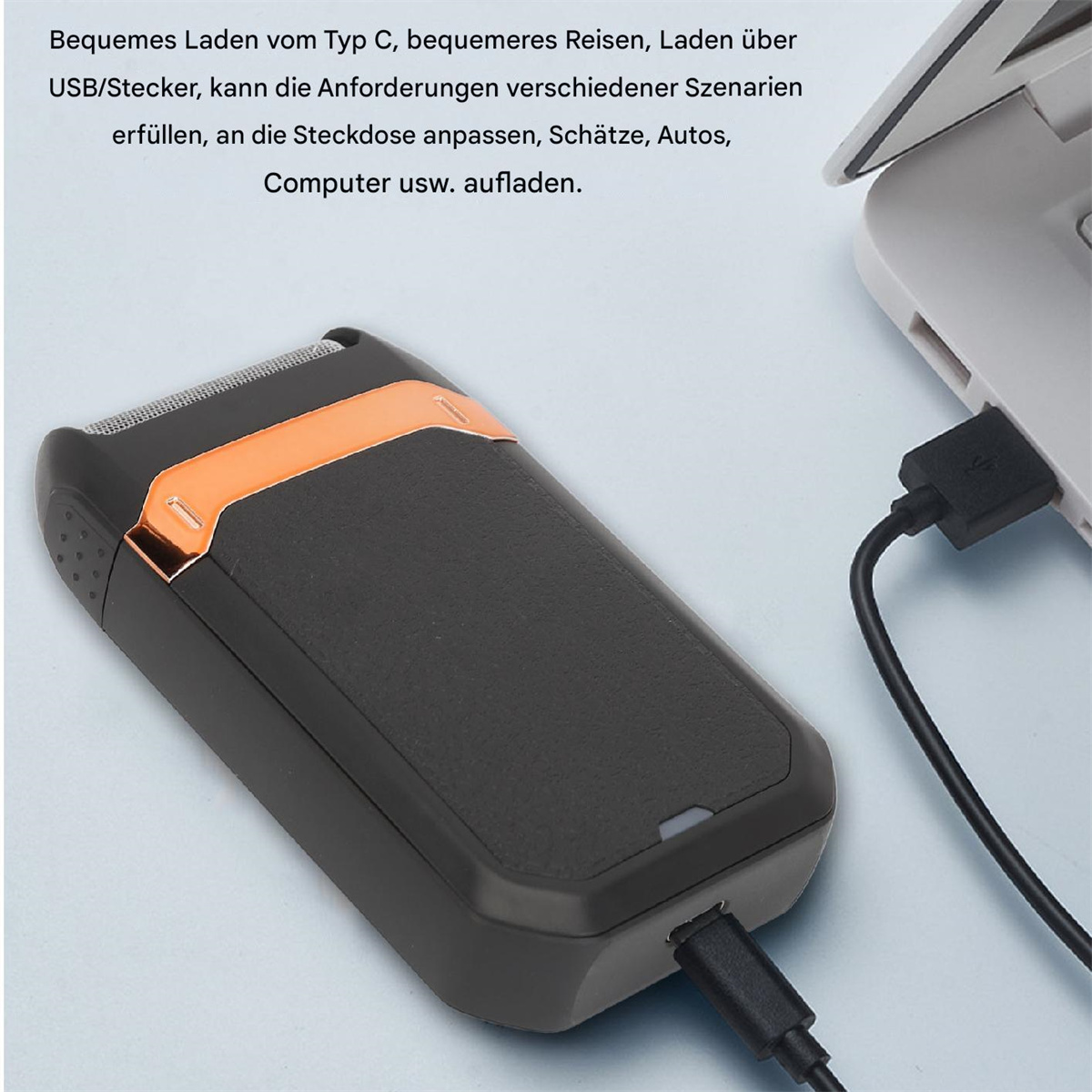 Elektrischer Rasierer, der über USB geladen wird. Schwarz-oranges Design. Text im Bild. Heller Hintergrund.
