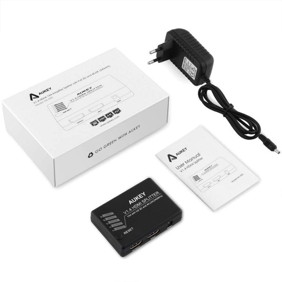 Weiße Box, HDMI-Splitter, schwarzer Splitter, Netzteil und Benutzerhandbuch auf weißer Oberfläche.