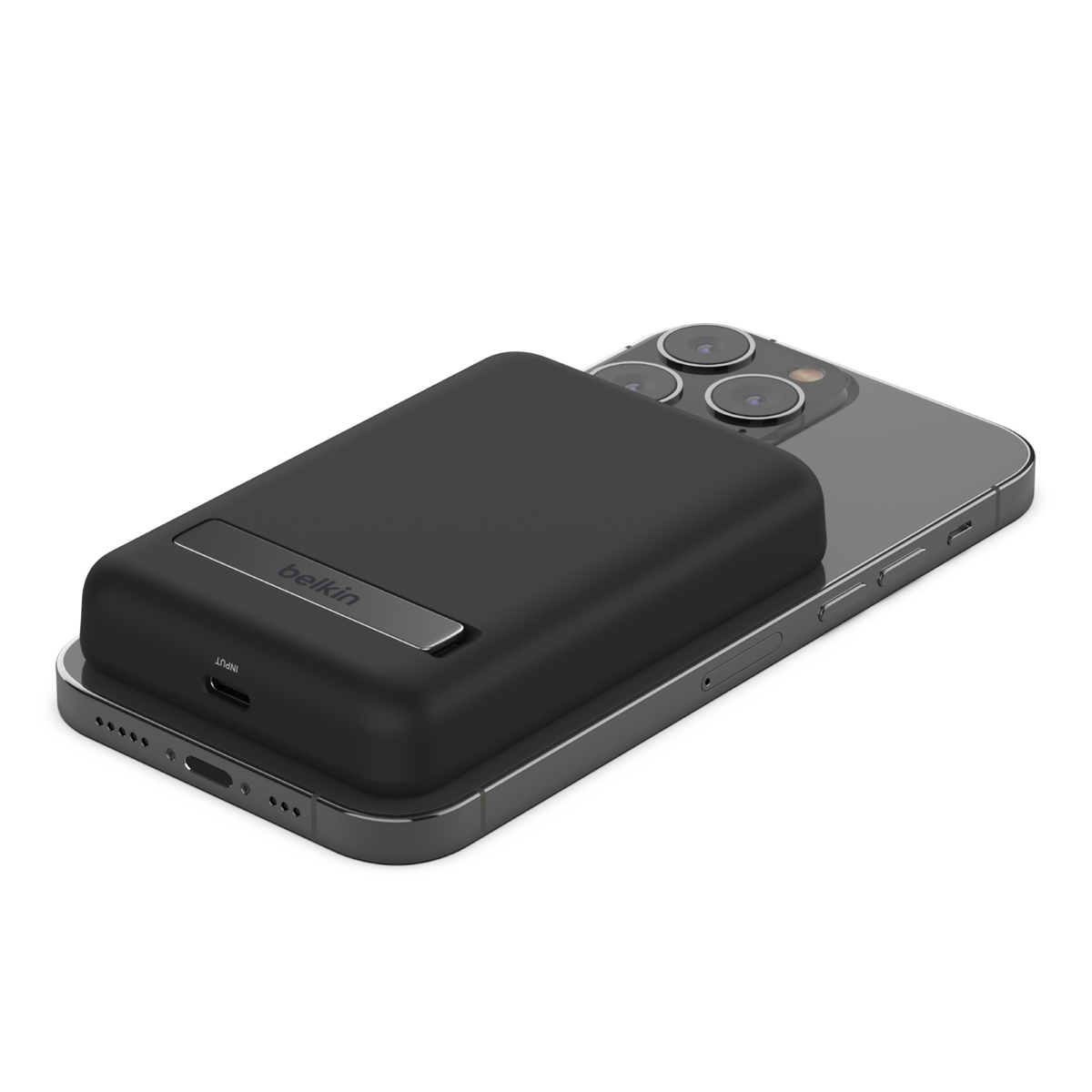 Zwarte Belkin draagbare oplader bevestigd aan een zilveren iPhone. De oplader ligt bovenop de telefoon.
