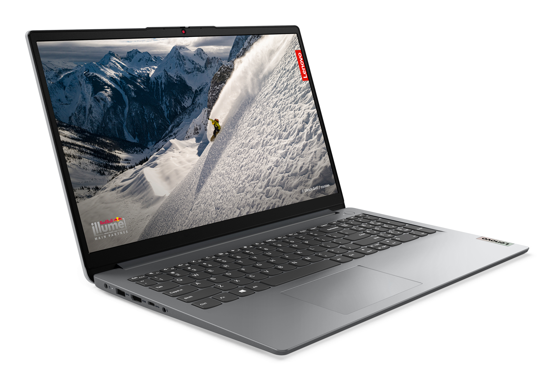 Szary laptop z zaśnieżonym krajobrazem górskim na ekranie.