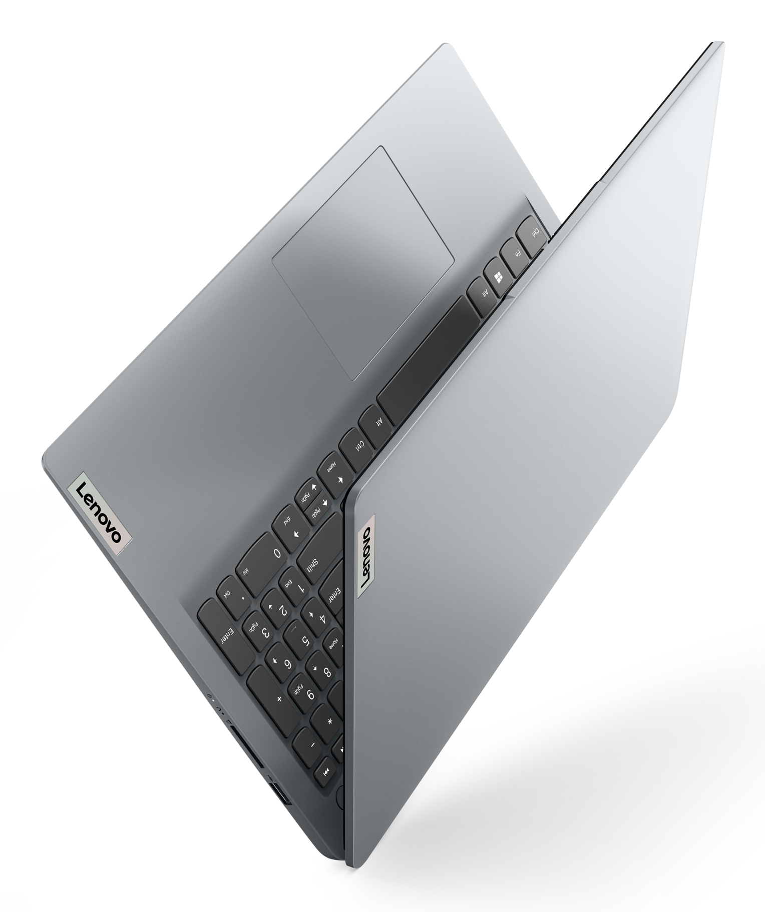 Szary laptop, otwarty na biurku. Klawiatura jest widoczna. Logo Lenovo jest widoczne.
