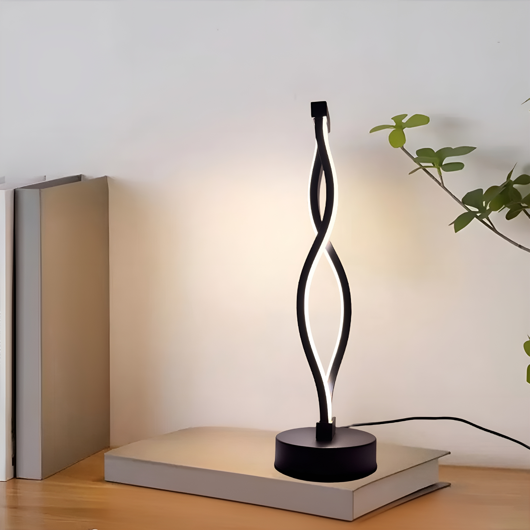 Moderne schwarz-weiße LED-Lampe auf einem Buch, mit einem Hintergrund aus Wand und einer Pflanze.