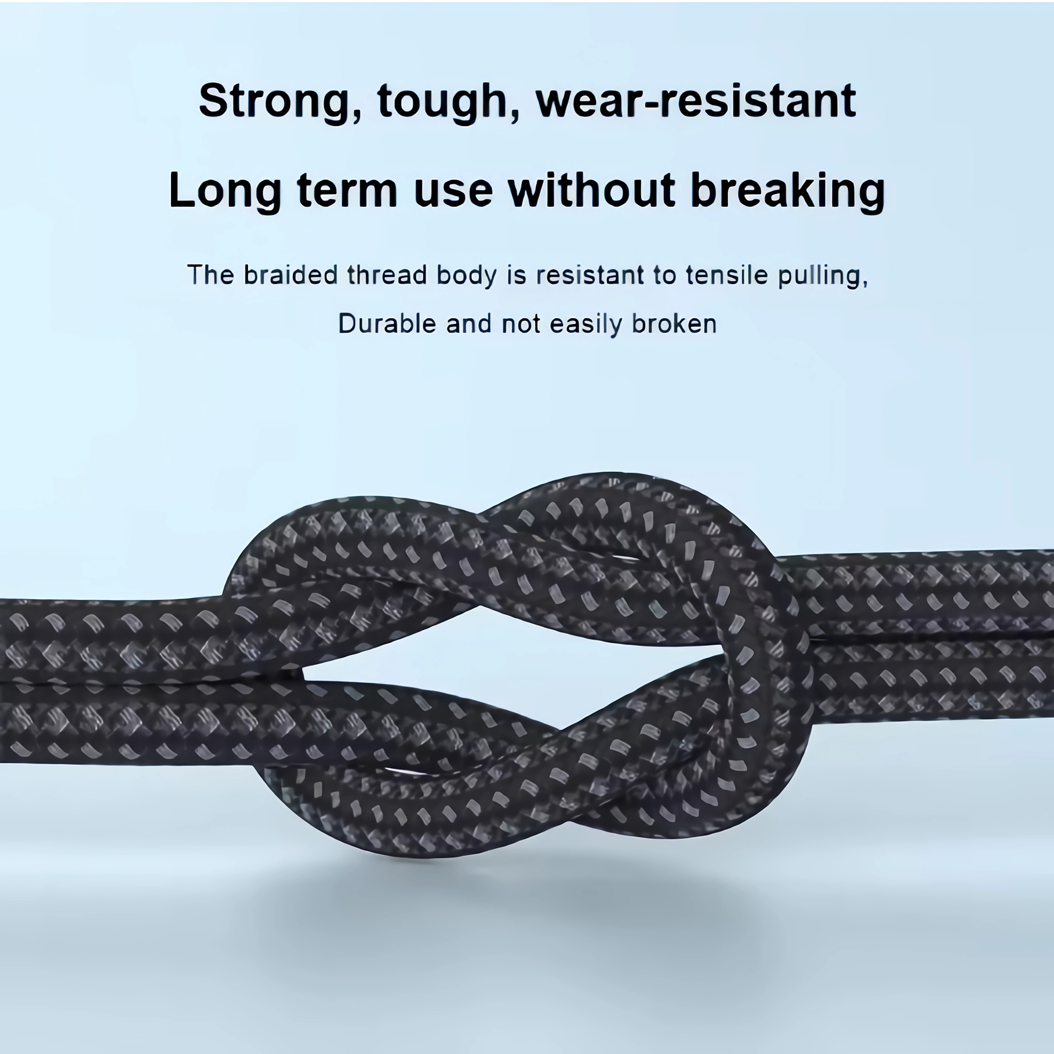 Geflochtenes schwarzes Kabel mit Knoten in der Mitte, Text über Haltbarkeit.