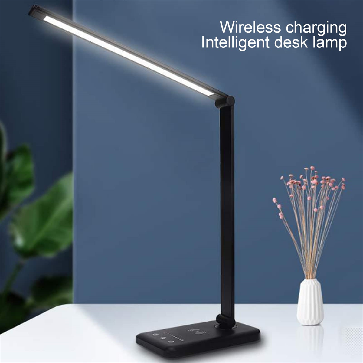 Eine schwarze Schreibtischlampe mit einer LED-Leuchte oben. Sie steht auf einem Schreibtisch mit einer Blumenvase.