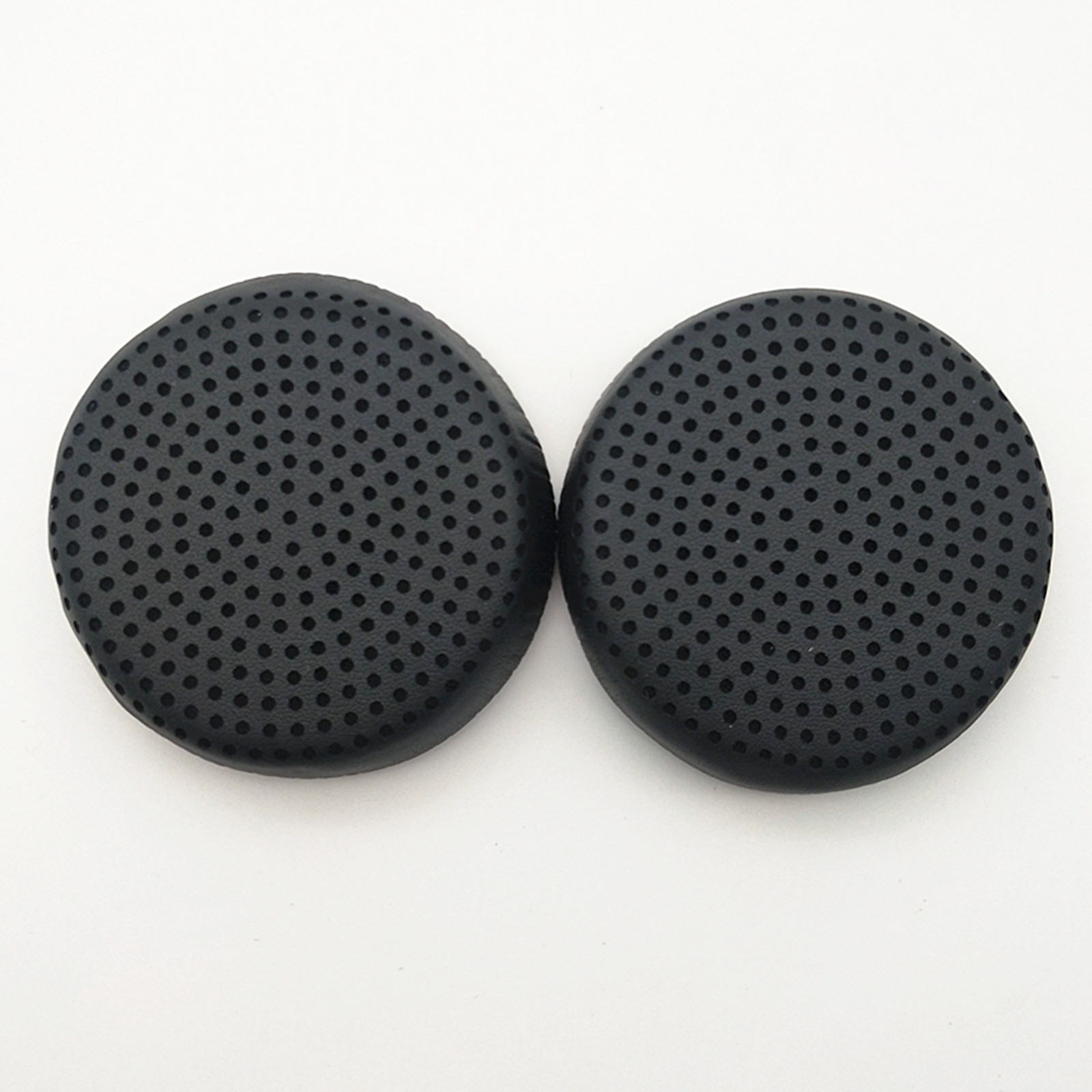 Due cuscinetti auricolari neri per cuffie con un design perforato, posizionati su una superficie bianca.