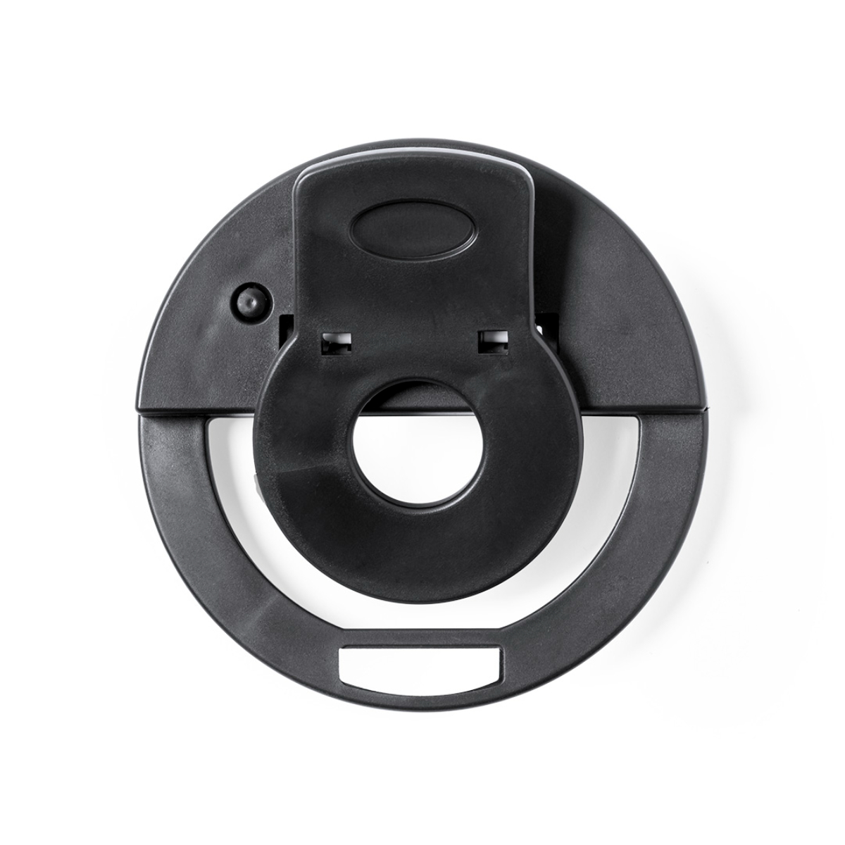 Soporte de teléfono negro en forma de anillo sobre una superficie blanca, con fijación central.