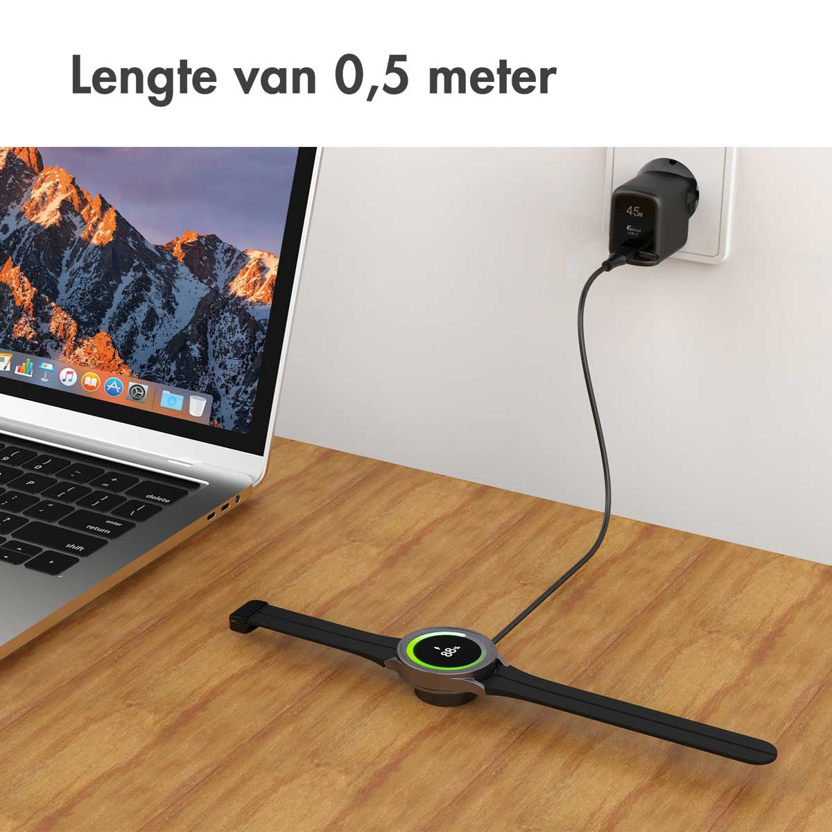 A black smartwatch charging on a wooden surface. A cable is connected to a wall charger.