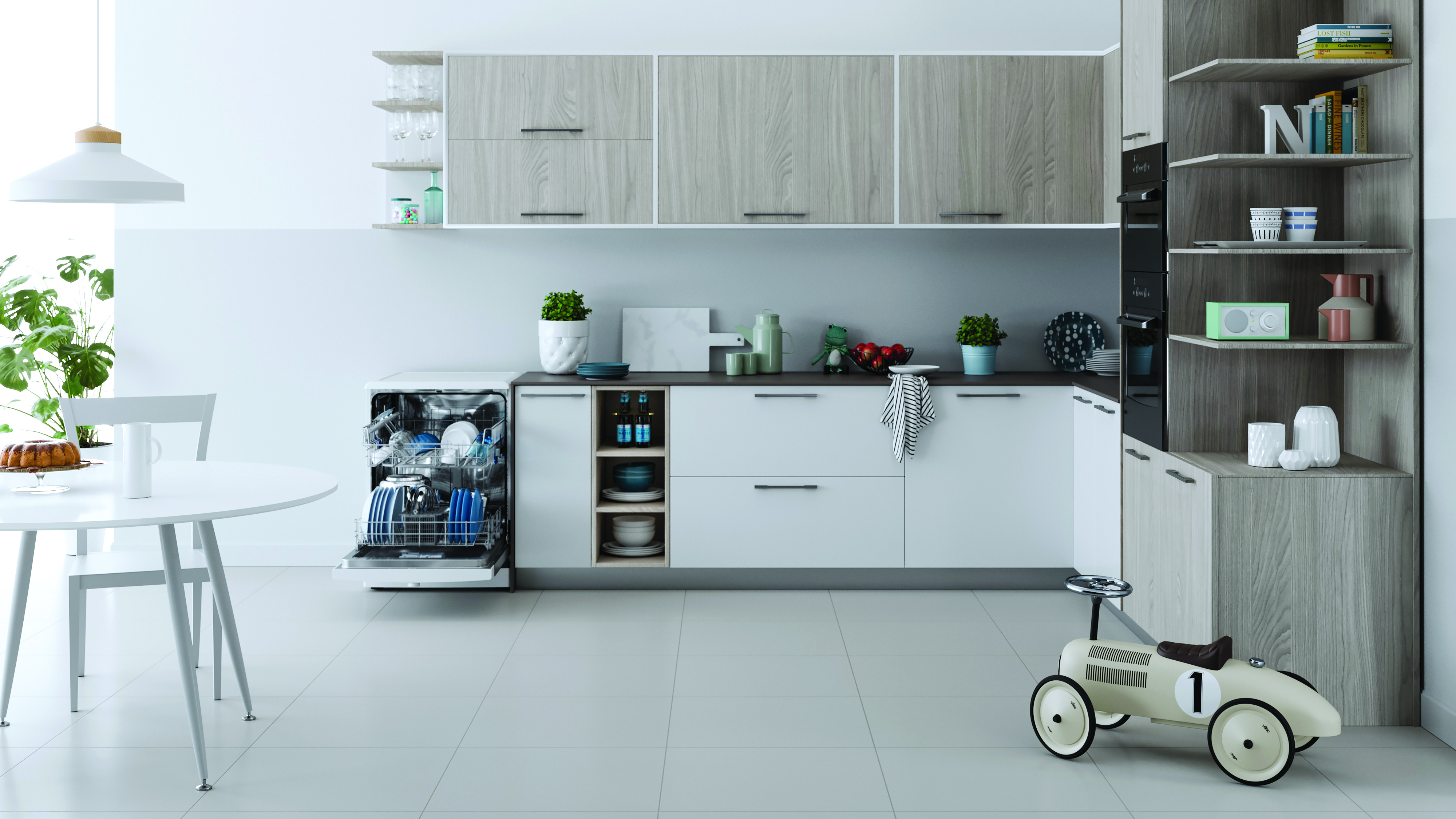 Cucina moderna con lavastoviglie aperta, tavolo con torta e auto giocattolo.