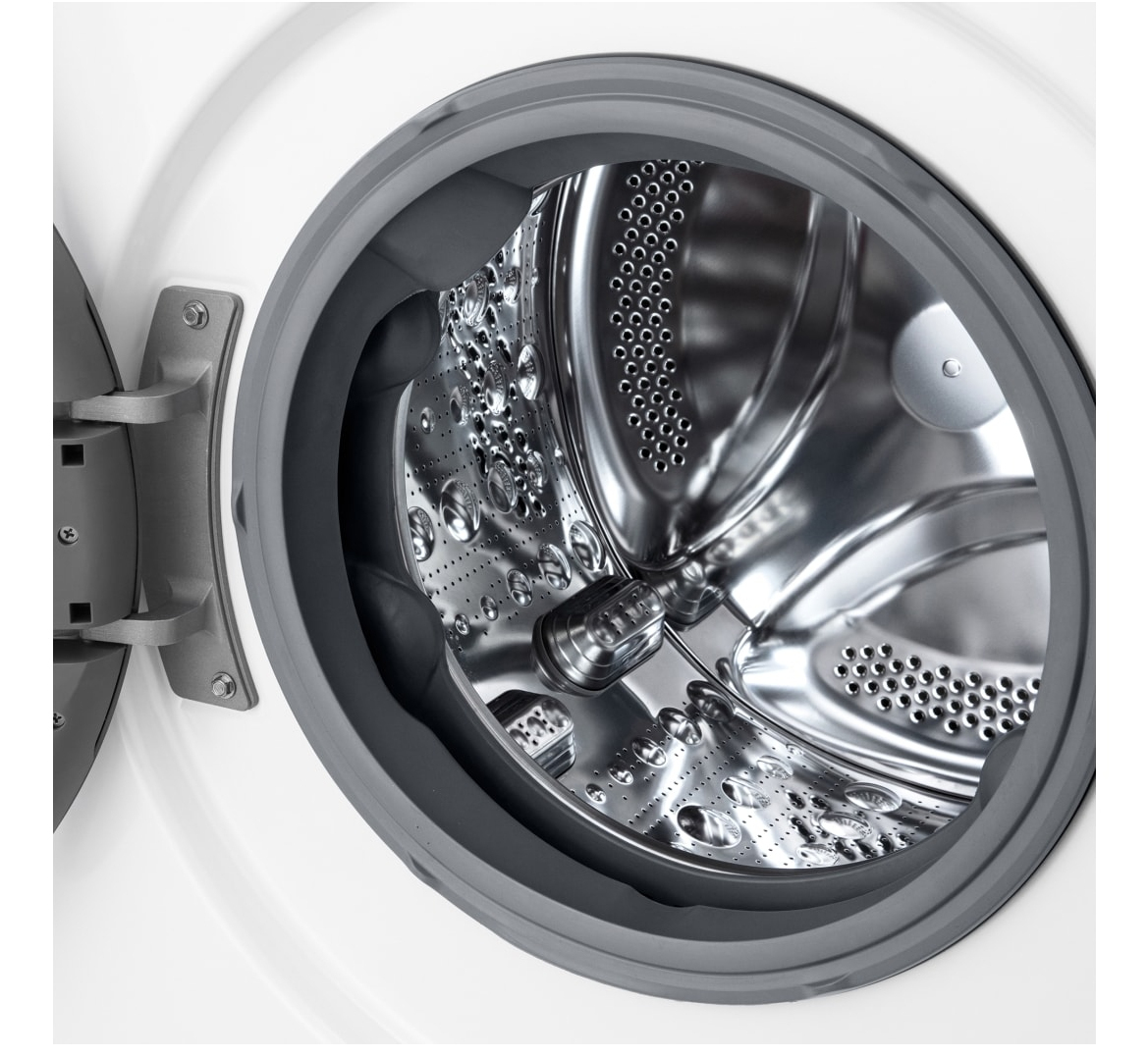 Wnętrze bębna pralki, błyszczący metal, z otworami i okrągłym otworem.