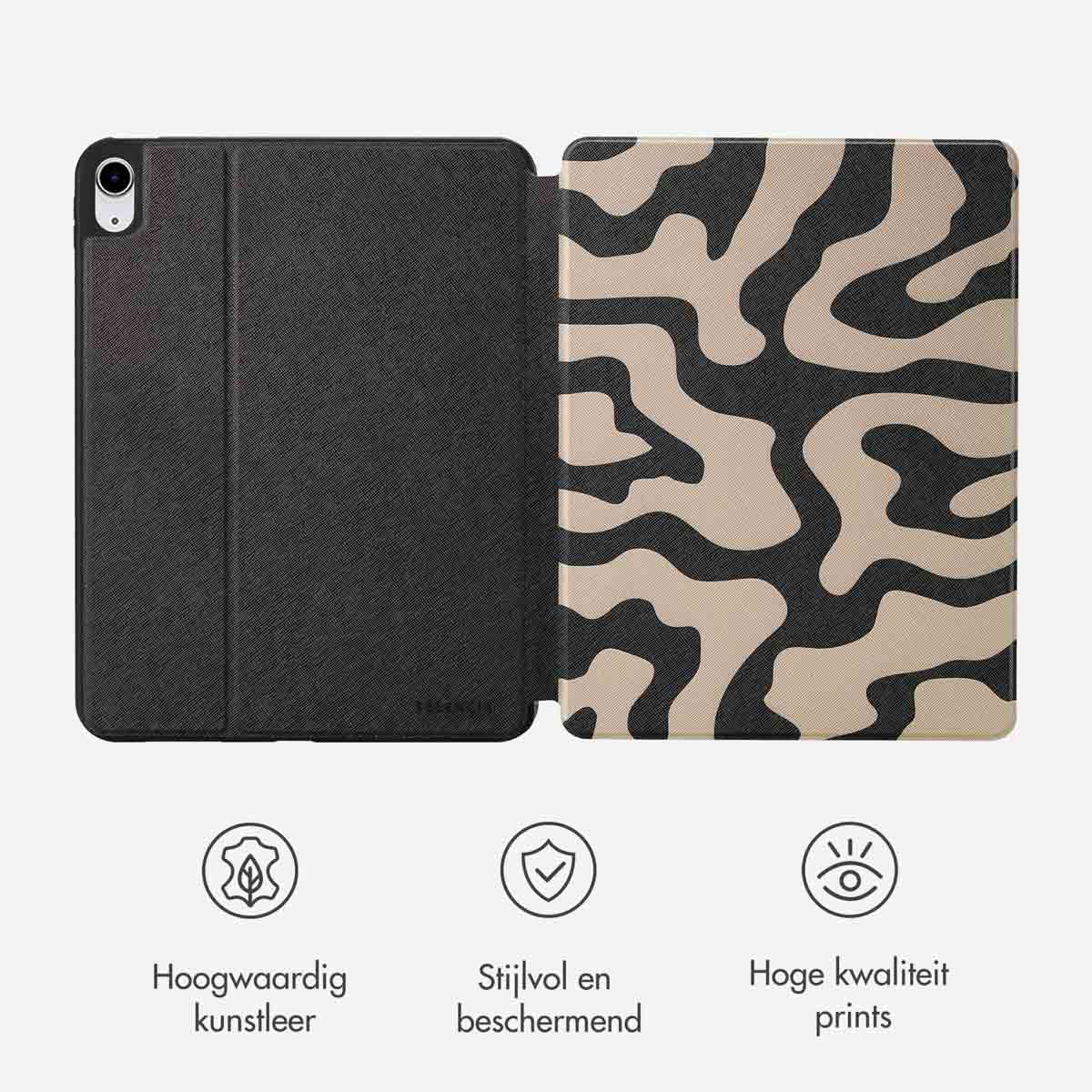 An open tablet case showing a black cover and a patterned interior with beige and black designs.