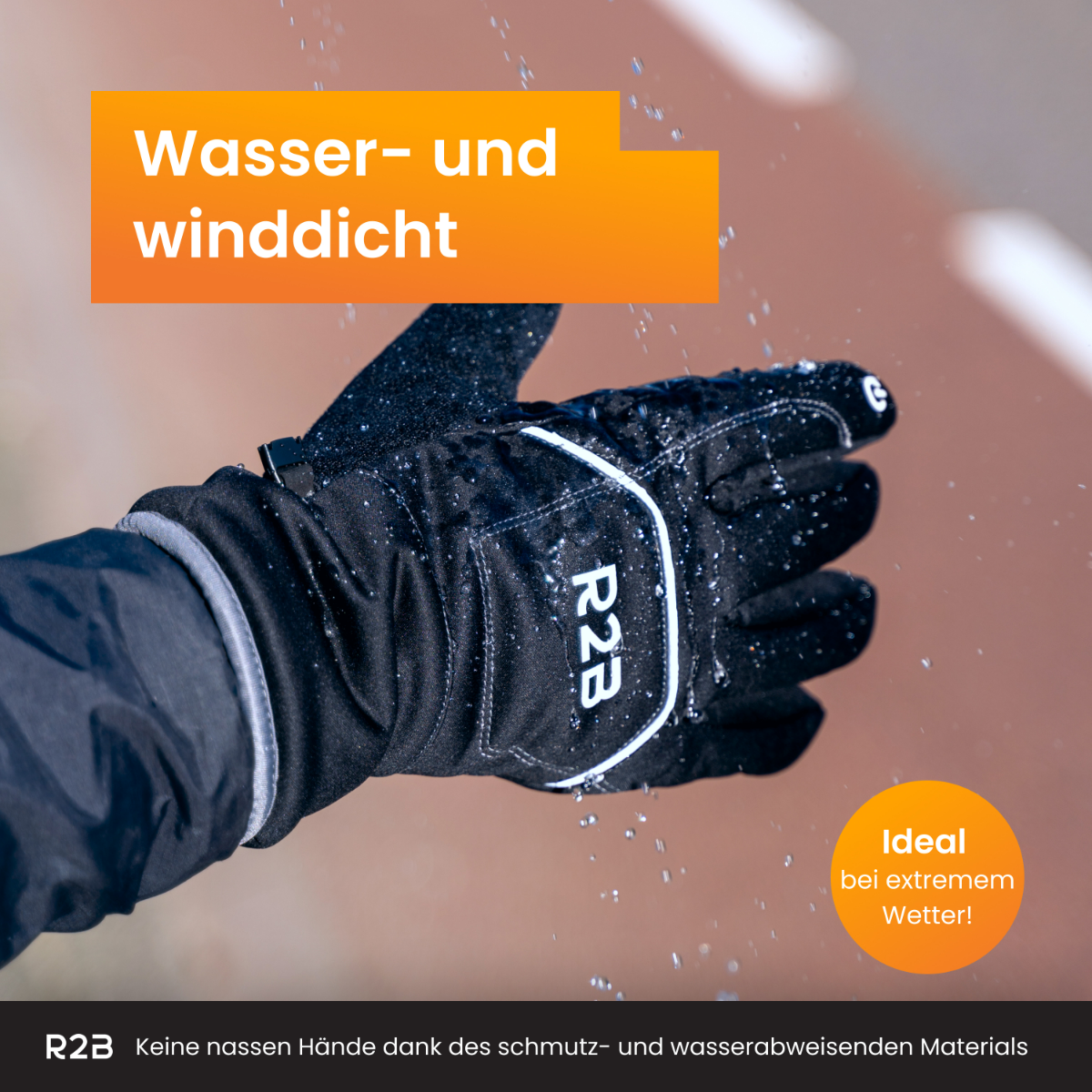 Black glove with R2B logo. Water and wind-resistant. Snowflakes are falling.