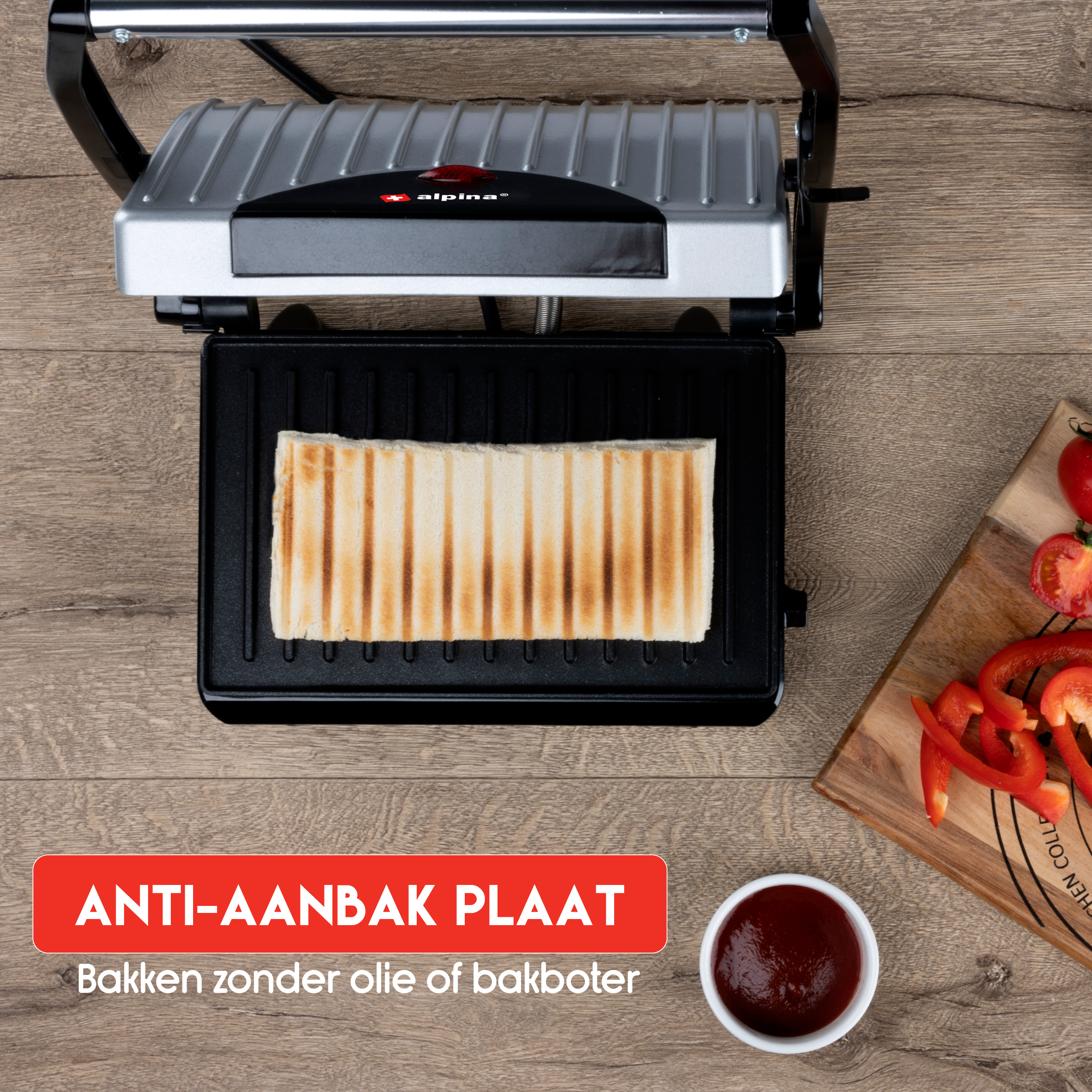 A panini press with a sandwich on the grill, next to ingredients on a board and a bowl.