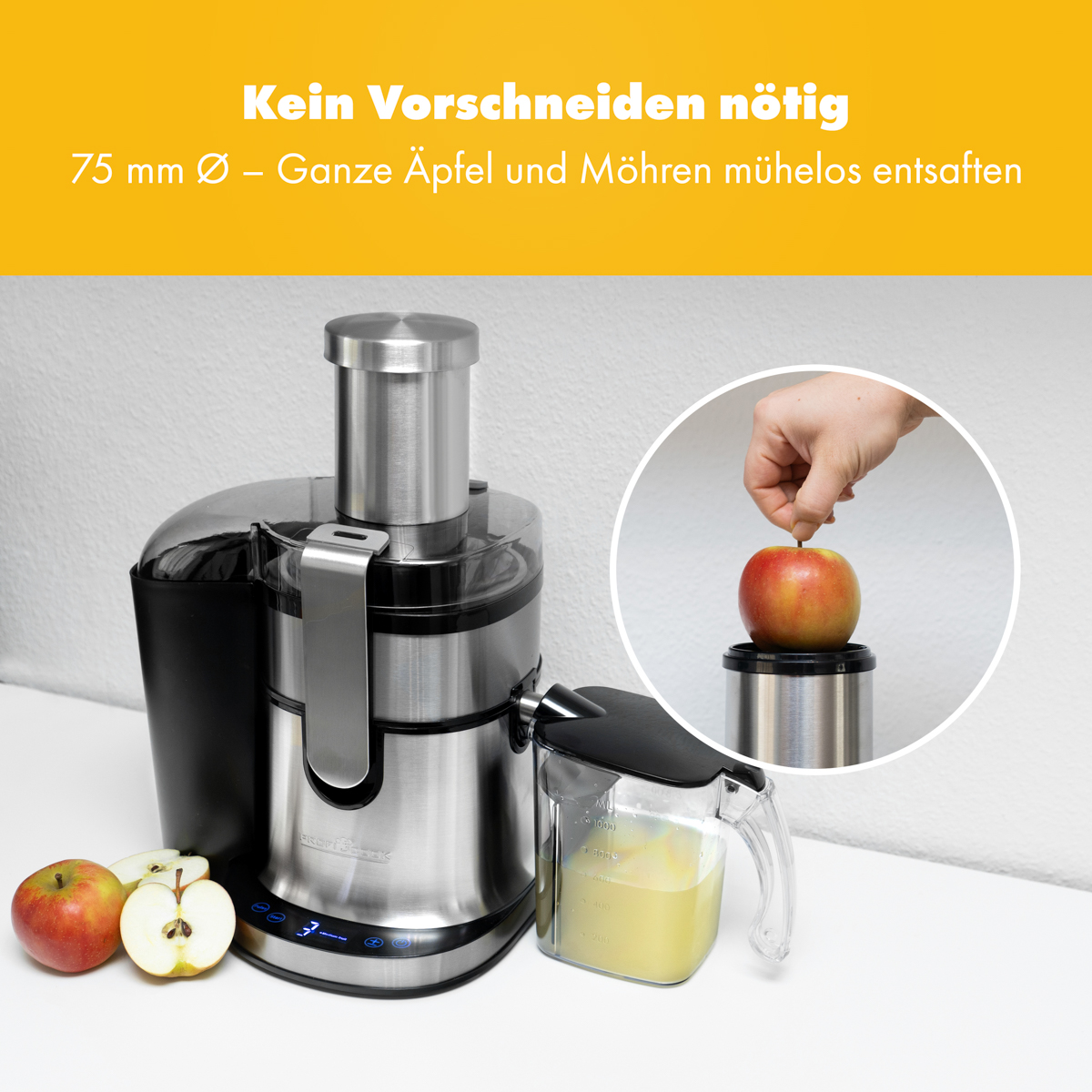 Wyrażarka z jabłkami. Jabłko jest umieszczane w wyciskarce.