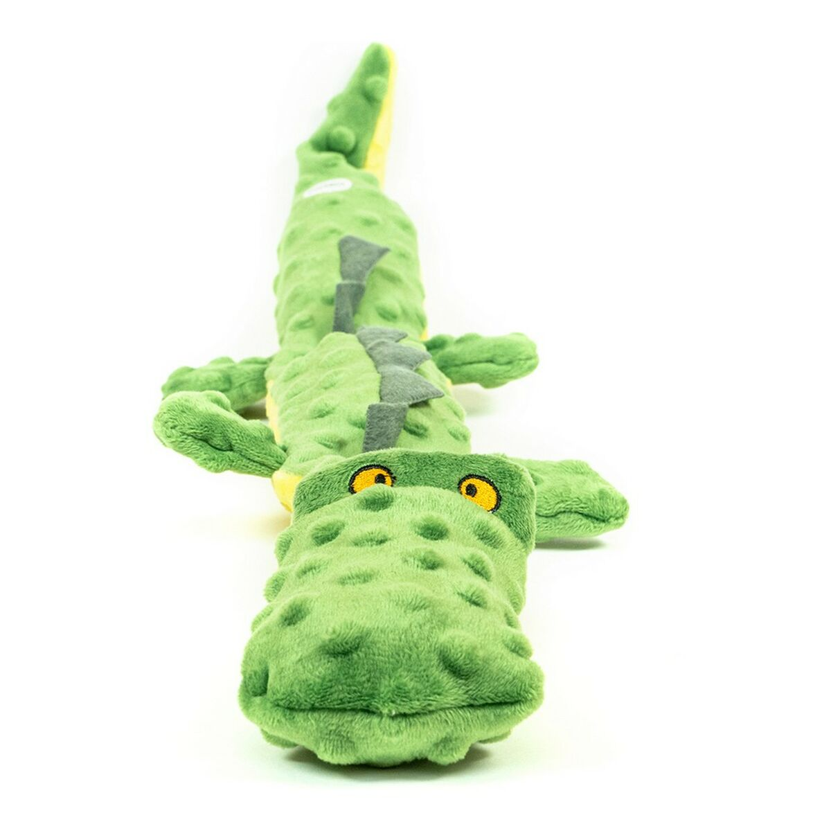 Peluche a forma di coccodrillo verde con dettagli gialli, su sfondo bianco.