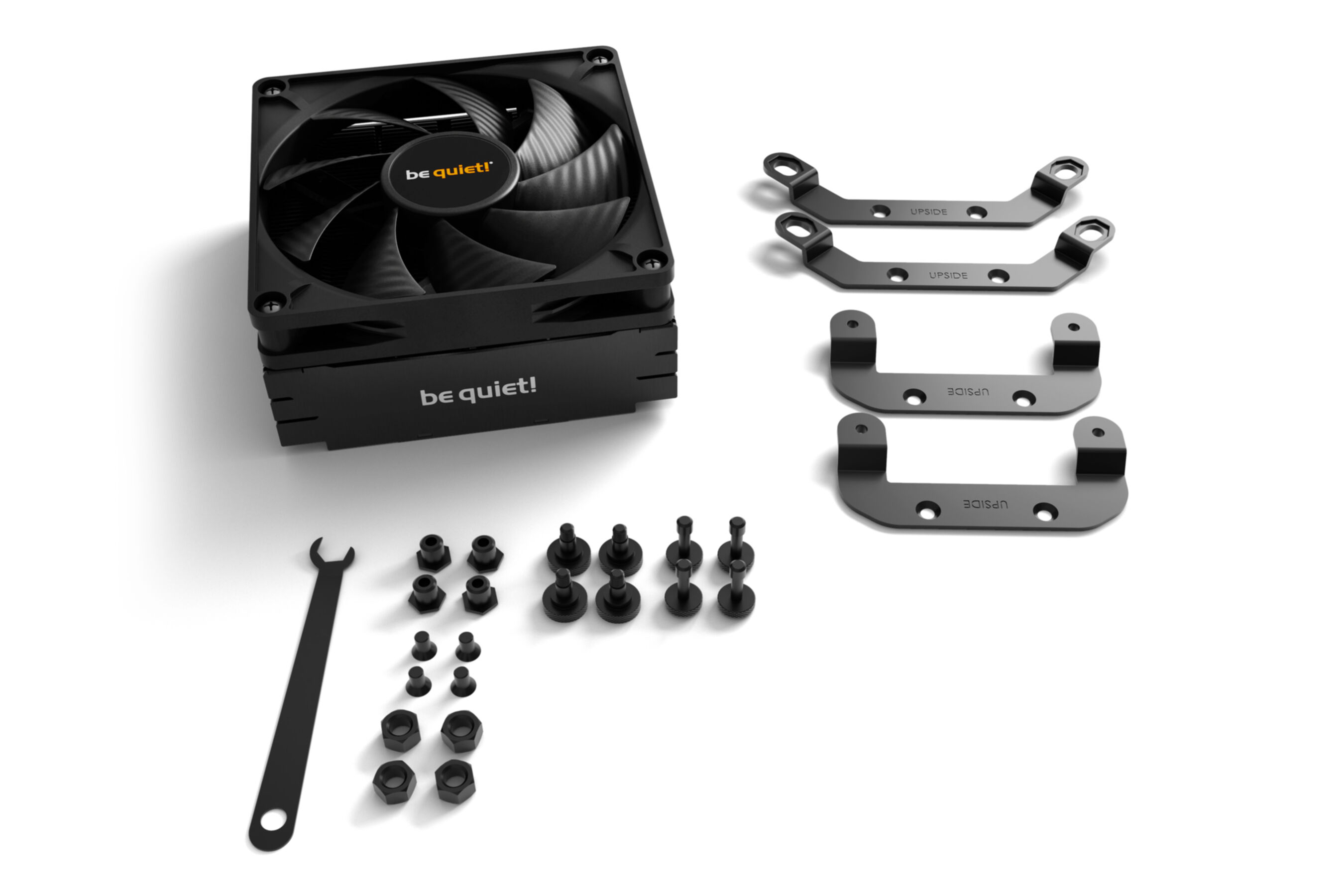 A black CPU cooler with a fan, with mounting brackets, screws, and a wrench. White background.