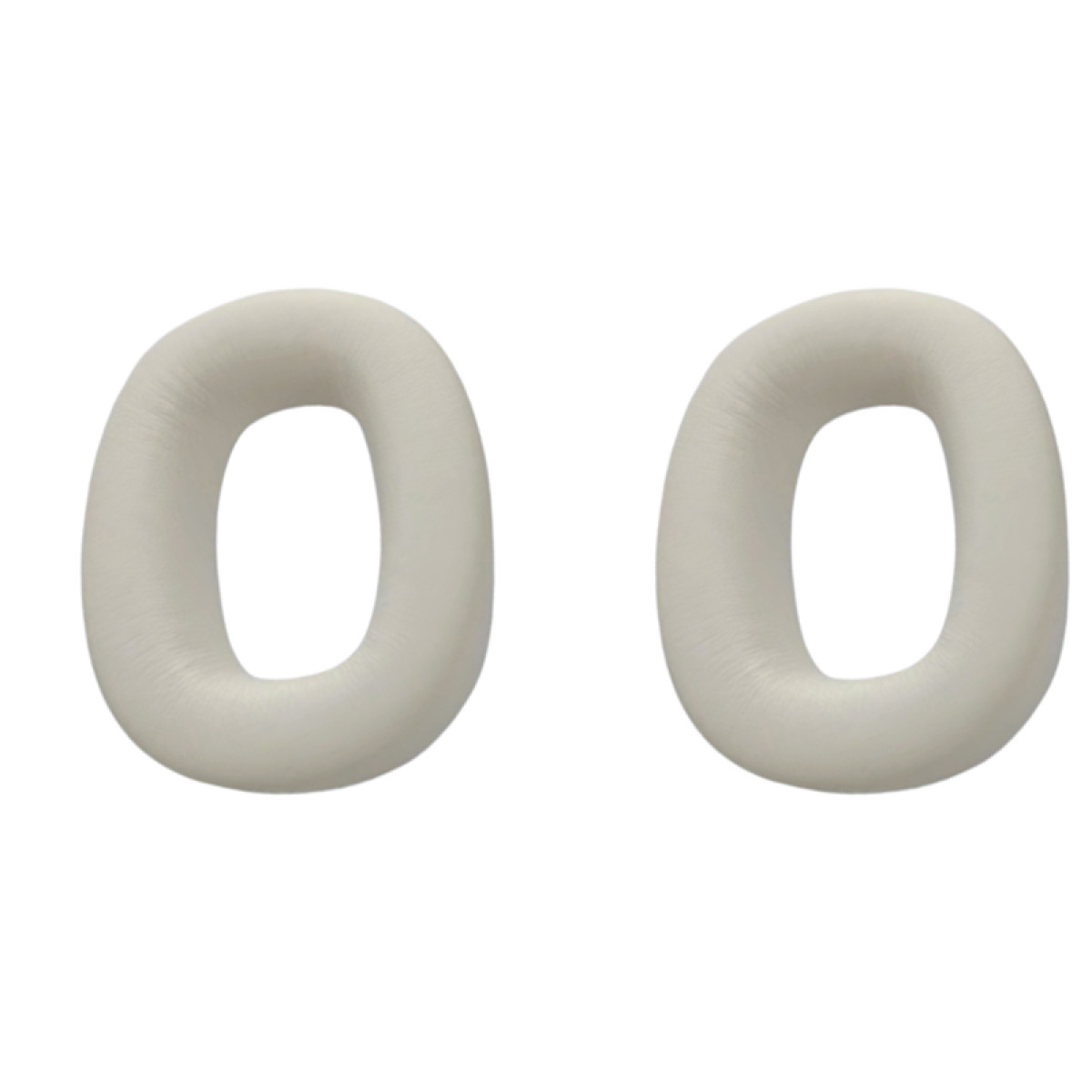 Dwie wkładki douszne, obie kremowe i okrągłe.