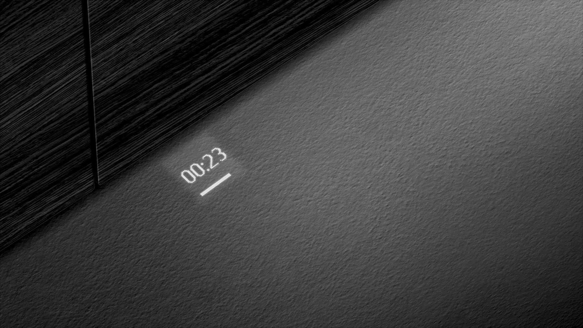 Une surface sombre avec un affichage de l'heure. L'heure est 00:23, avec un effet de projection.