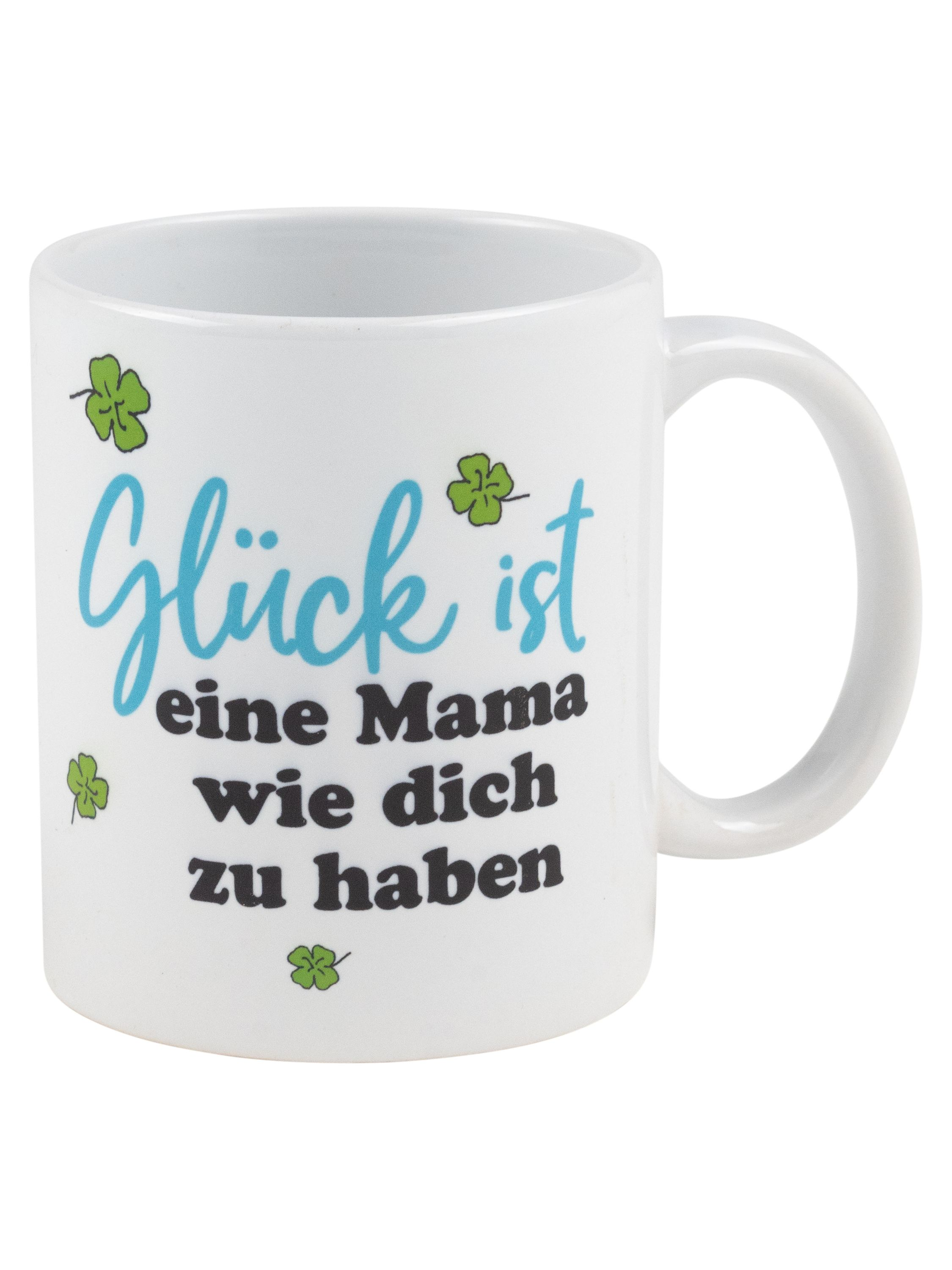 Weißer Becher mit Botschaft in Blau und Grün. Kleeblatt-Dekorationen. Weißer Hintergrund.