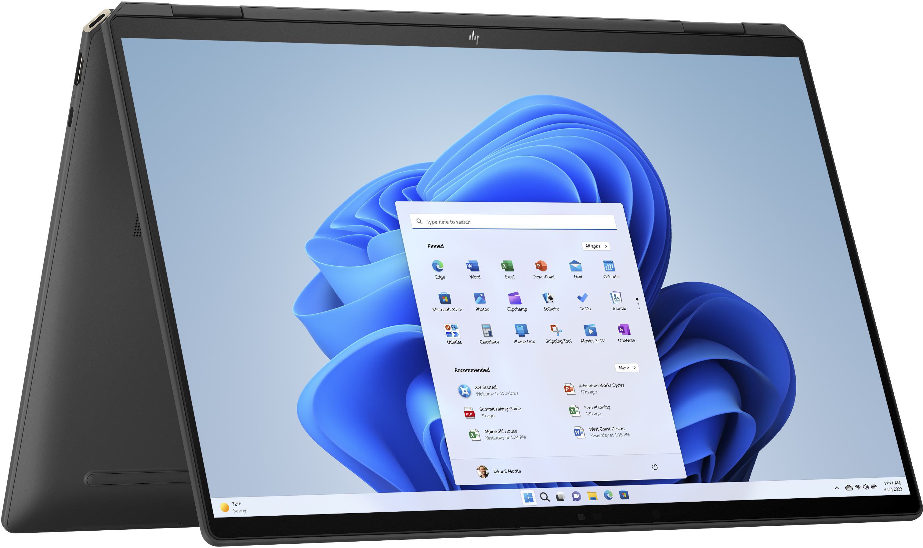 Laptop z otwartym systemem Windows 11, pokazujący menu start z ikonami aplikacji.
