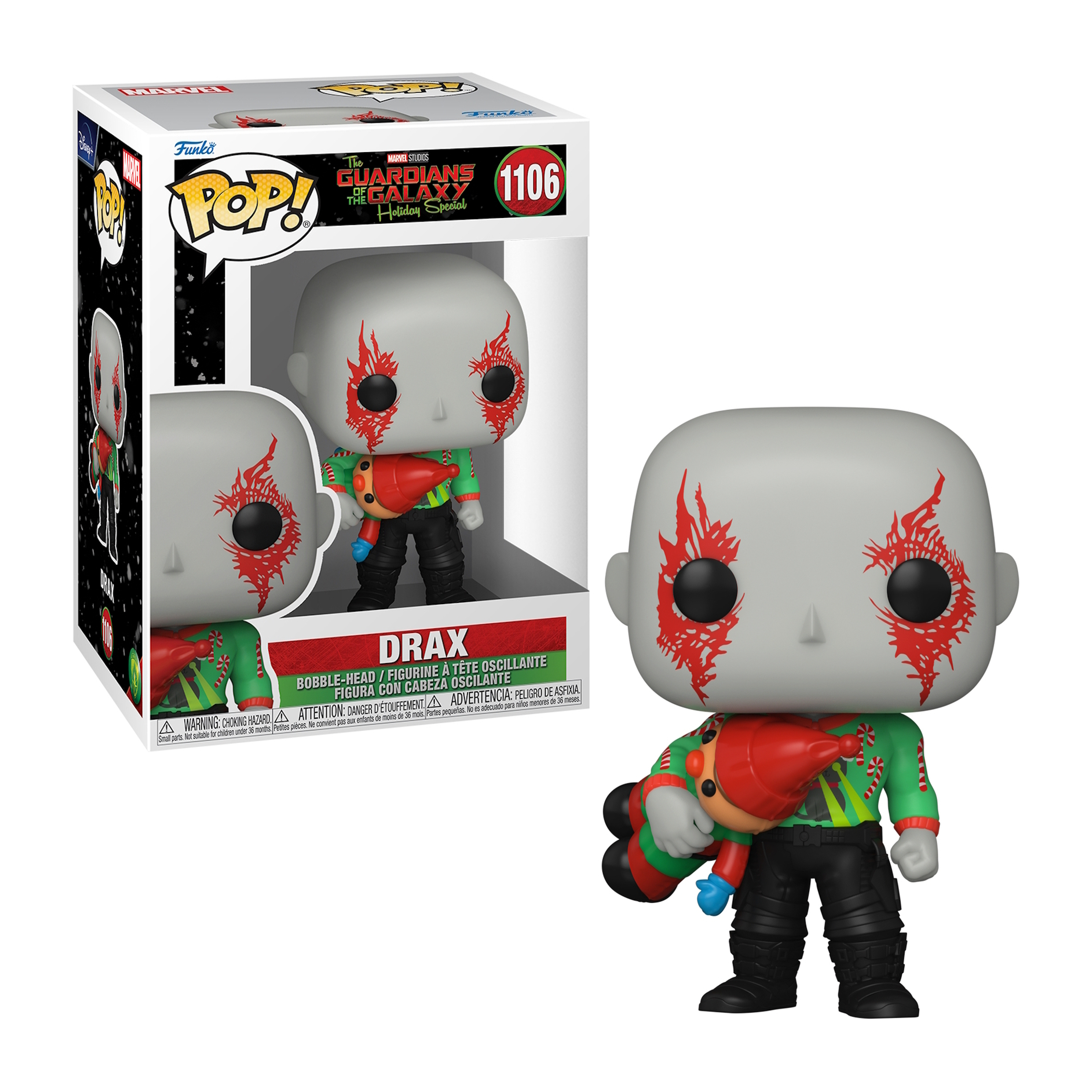 Figurka Funko Pop Draxa w świątecznym stroju i z zabawką. Pudełko w tle.