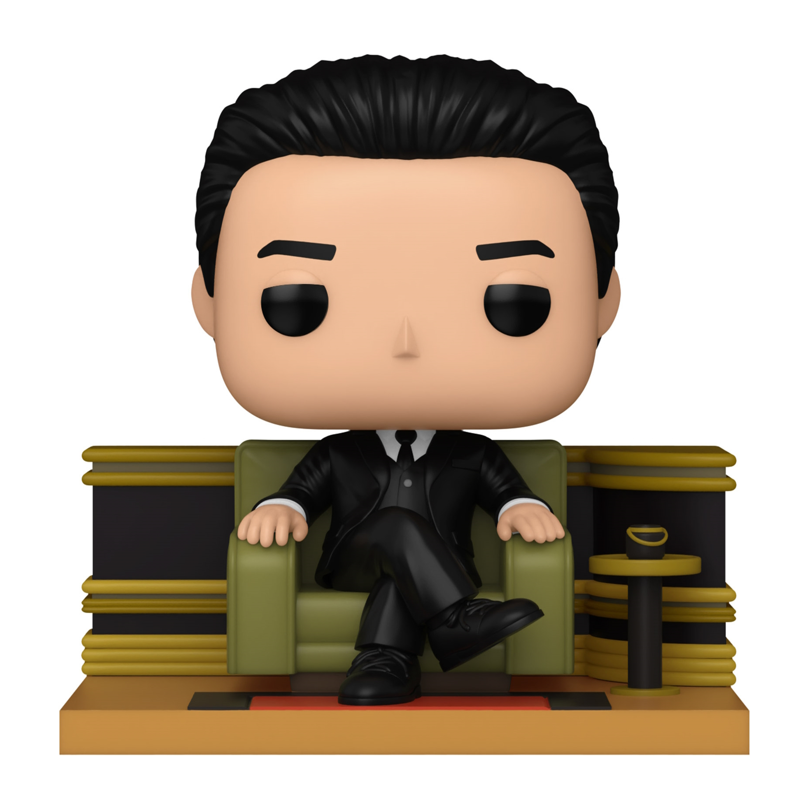 Funko Pop di un uomo in abito seduto su una sedia verde su un palco.