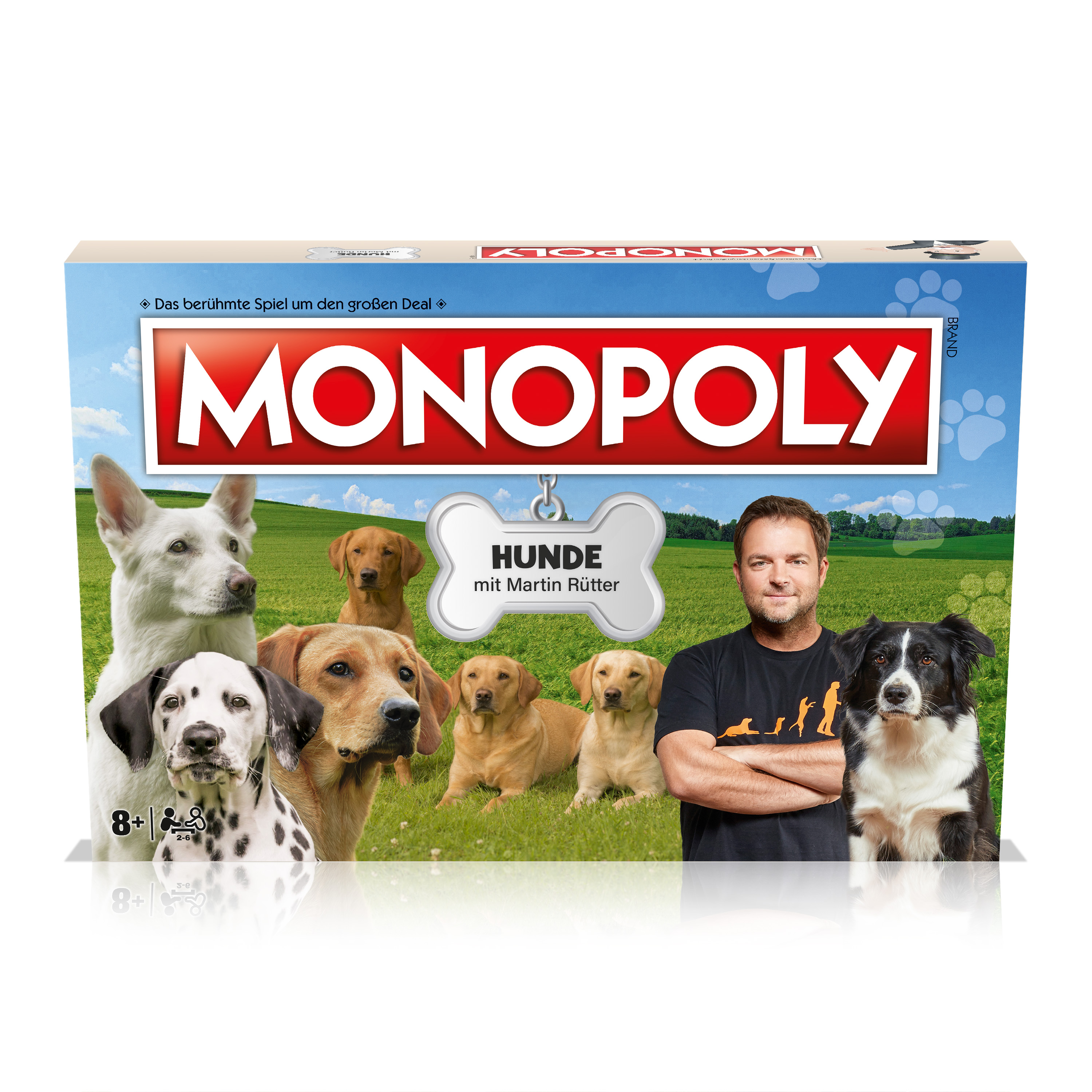 Das Monopoly-Brettspiel mit Hunden auf der Verpackung, mit einem Mann und verschiedenen Hunderassen.