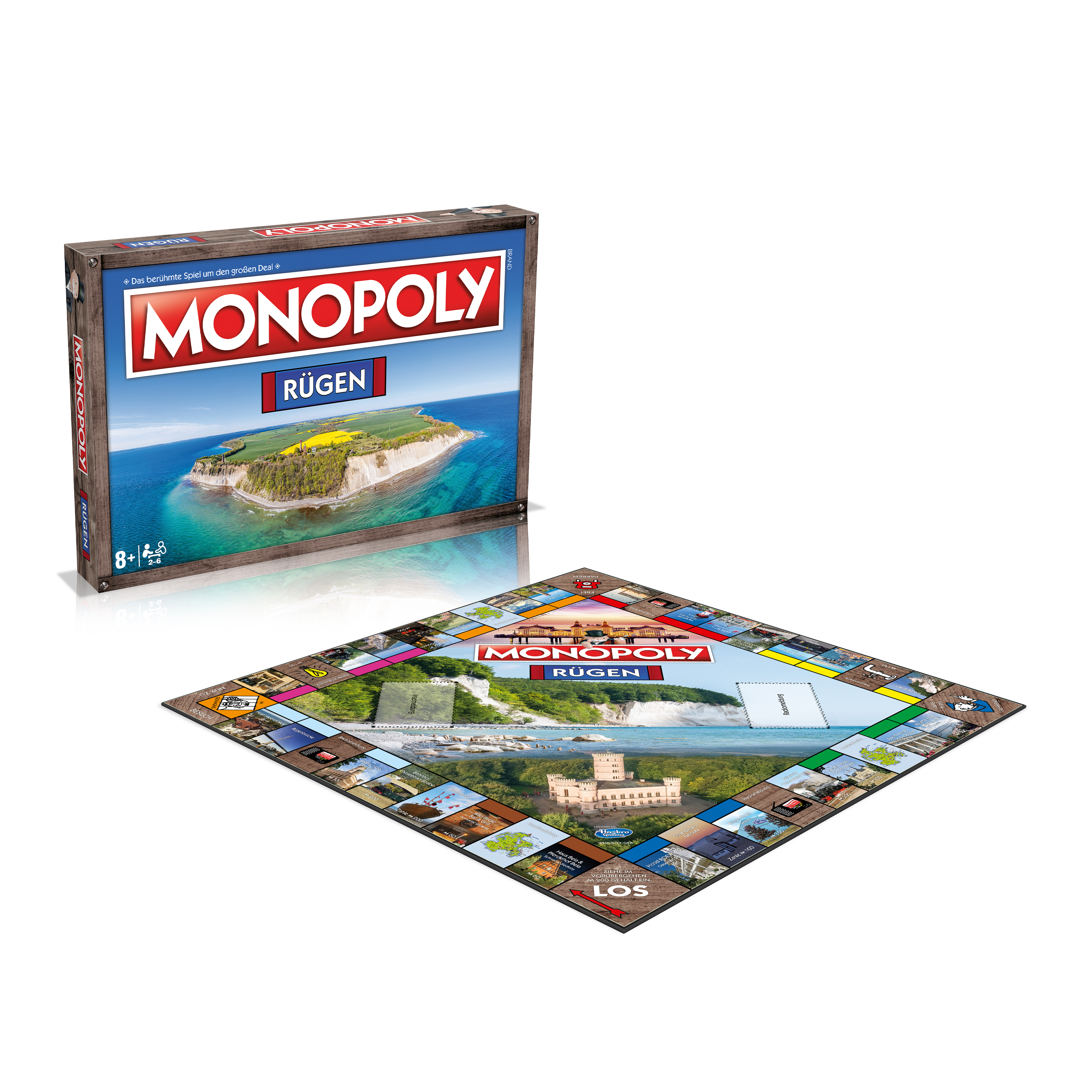 Monopoly-Spielbrett. Eine Box und das Brett zeigen eine Insel-Szene. Das Brett hat verschiedene Immobilienbilder.