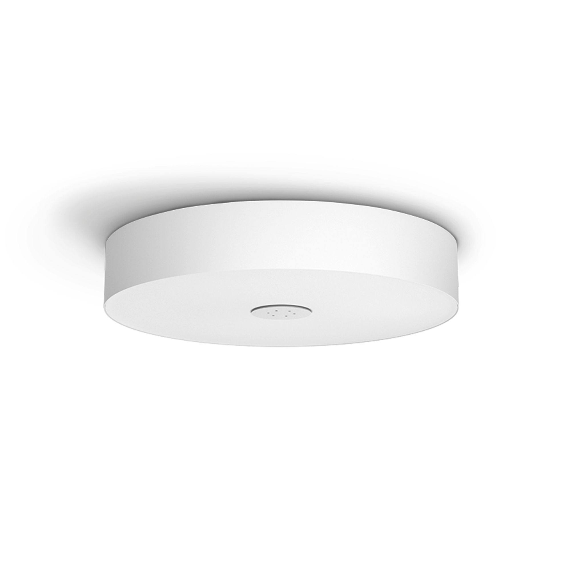 Plafonnier blanc. Forme circulaire, avec un petit trou au centre du bas.