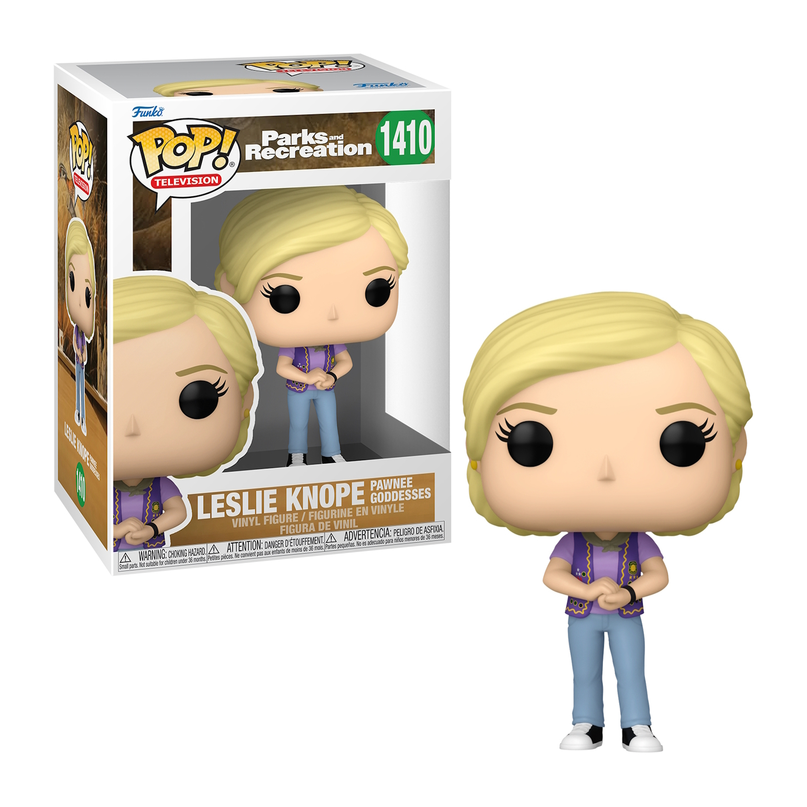 Leslie Knope-Figur. Blondes Haar, lila Weste, blaue Jeans. Verpackt. Arme verschränkt, lächelnd.