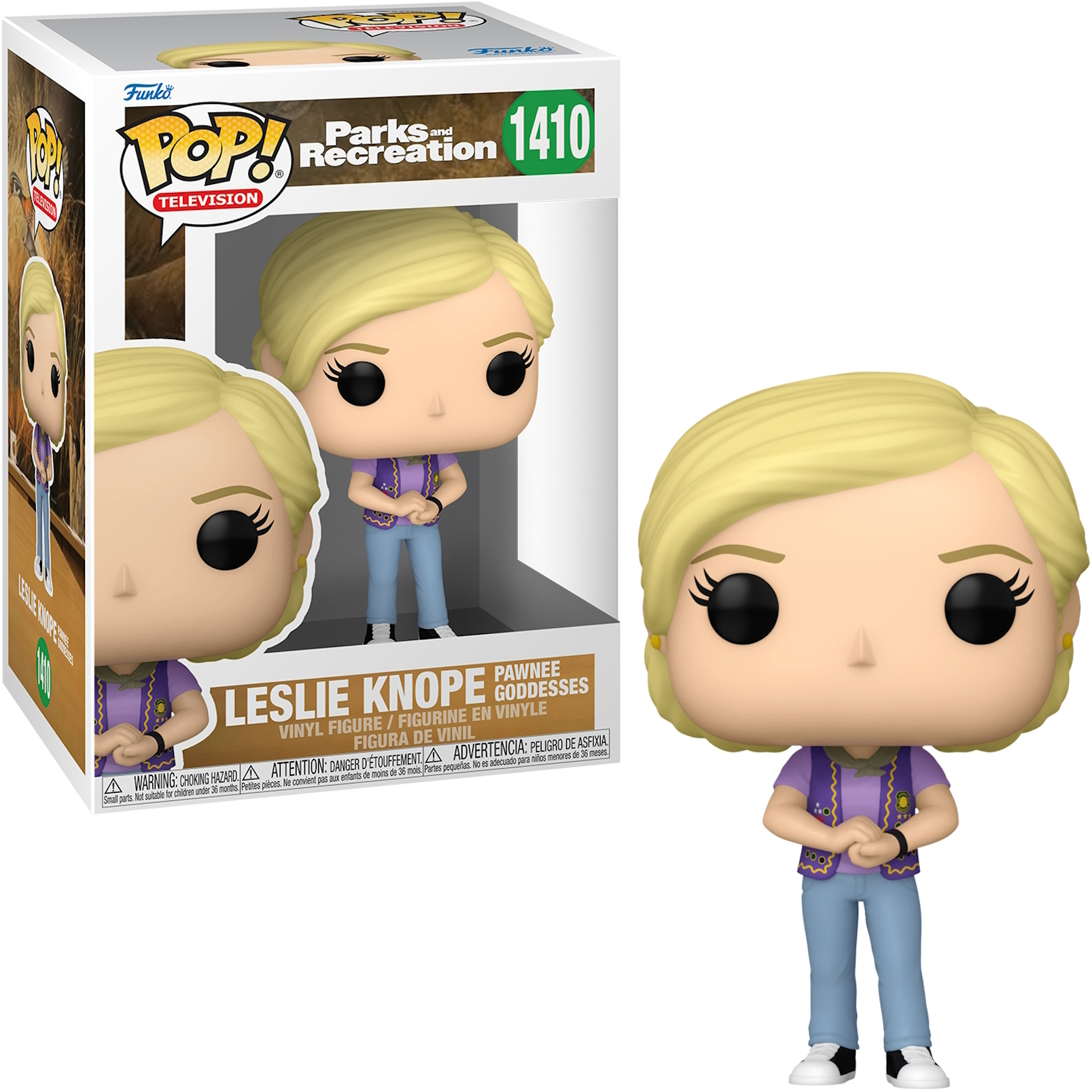 Leslie Knope Funko Pop. Blondes Haar, lila Oberteil, blaue Hose. Box hat ein Bild von ihr.